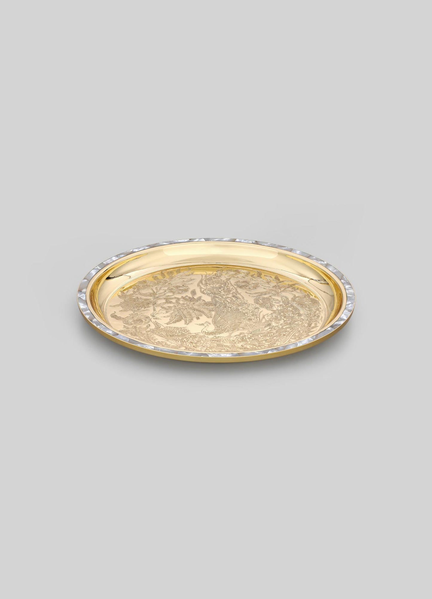 Gold-toned metal tray with intricate engraved floral and foliage motifs, featuring a decorative border with clear crystal accents, set against a plain background.