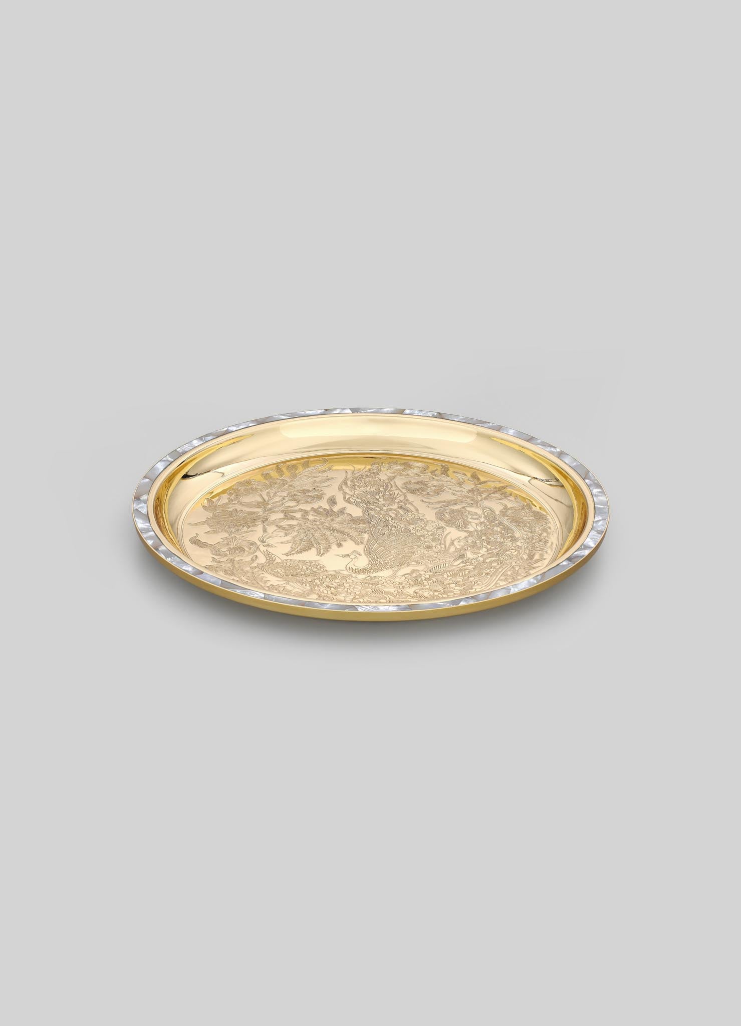 Gold-toned metal tray with intricate engraved floral and foliage motifs, featuring a decorative border with clear crystal accents, set against a plain background.
