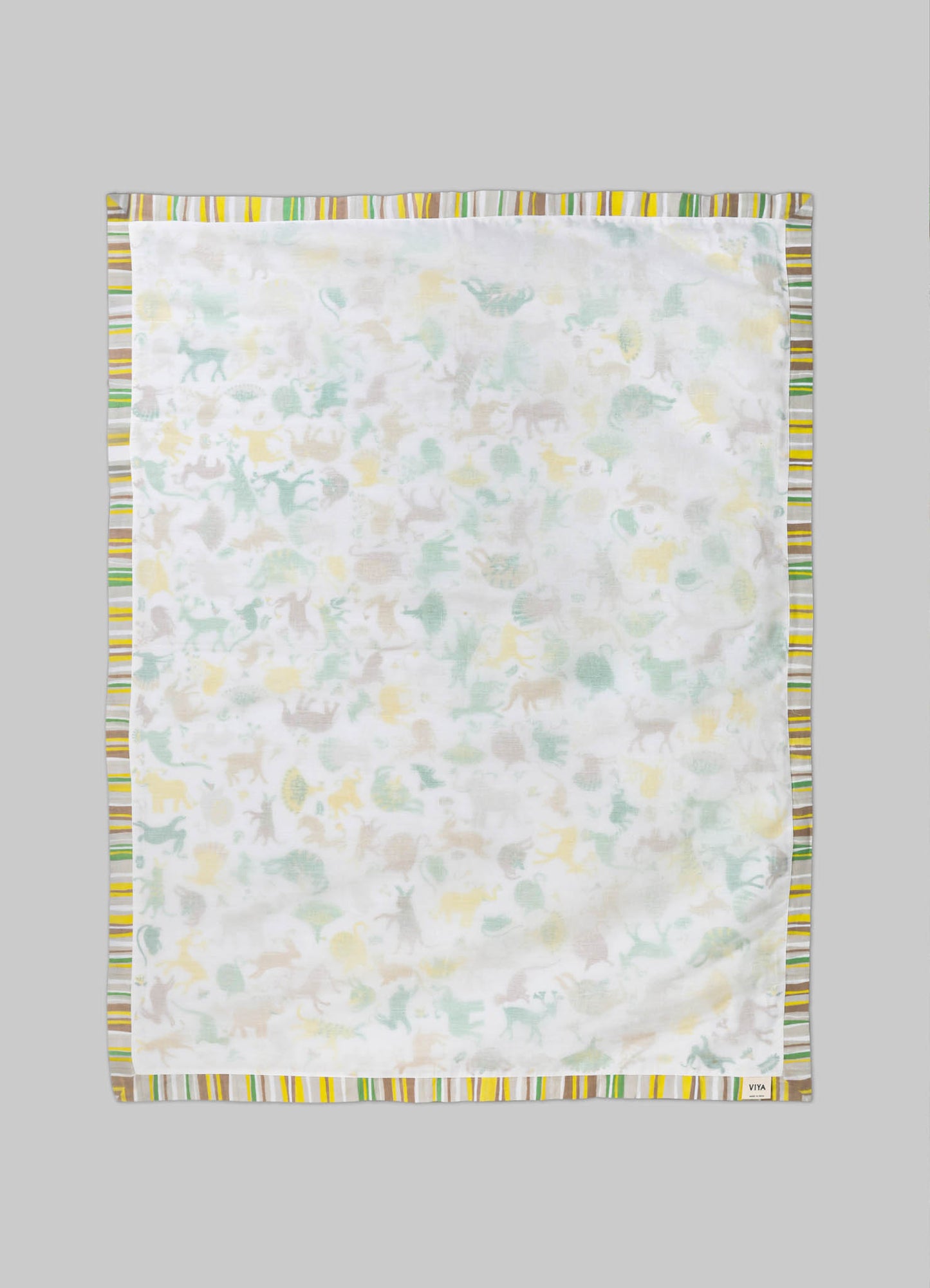 Cotton baby blanket with a multicolored striped border and a subtle animal print pattern in pastel shades of yellow, green, and beige on a white background.