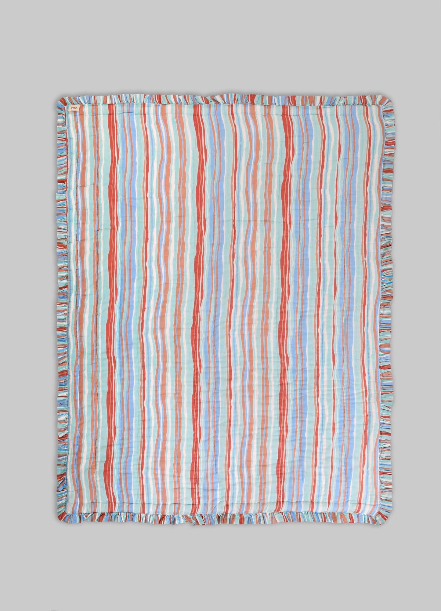 Striped cotton bed throw with multicolored vertical lines in shades of red, blue, and beige, featuring a ruffled edge.