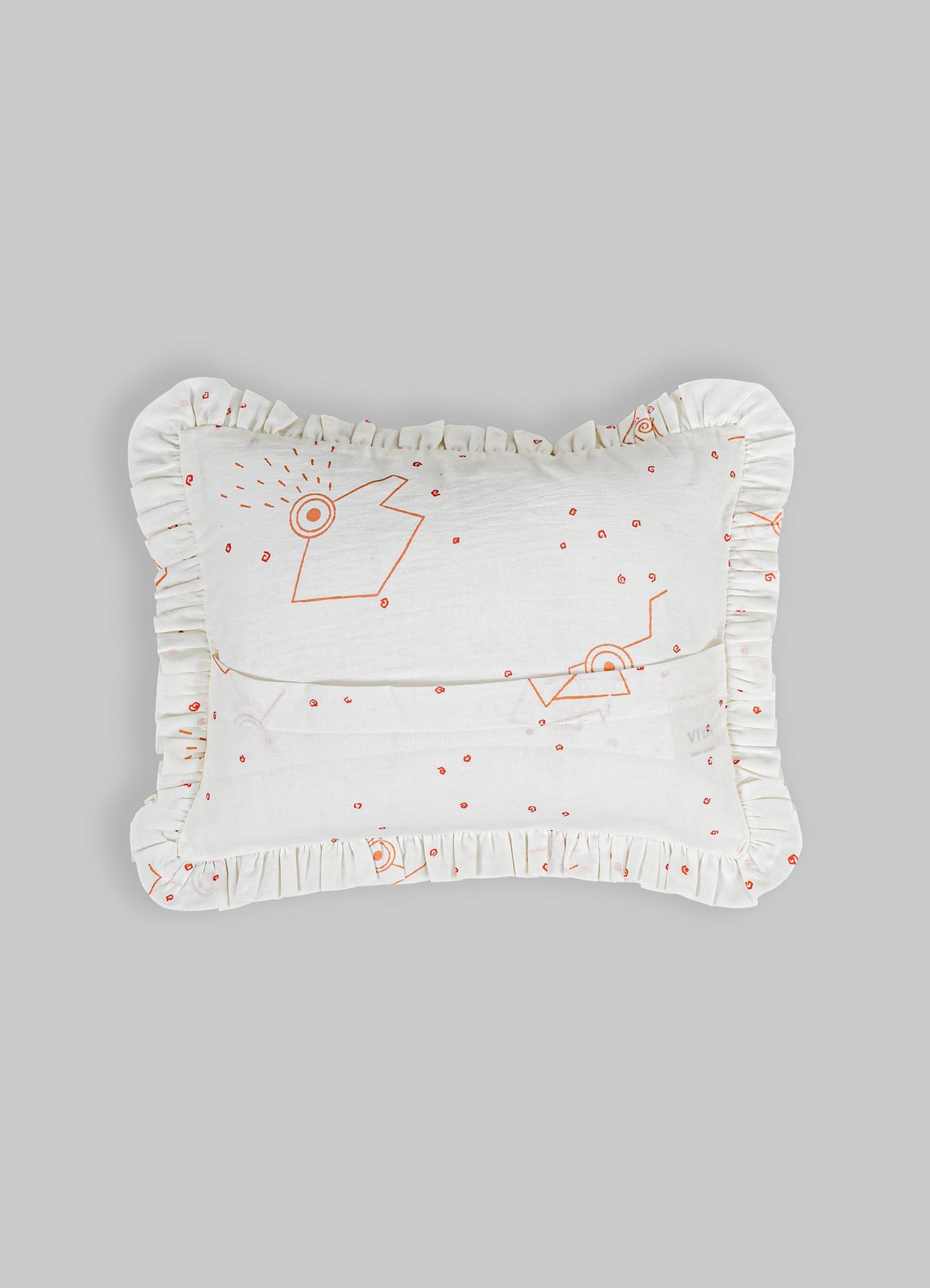 A rectangular pillow with ruffled edges, made of white fabric with an orange line drawing pattern featuring abstract shapes and small dots, on a plain background.
