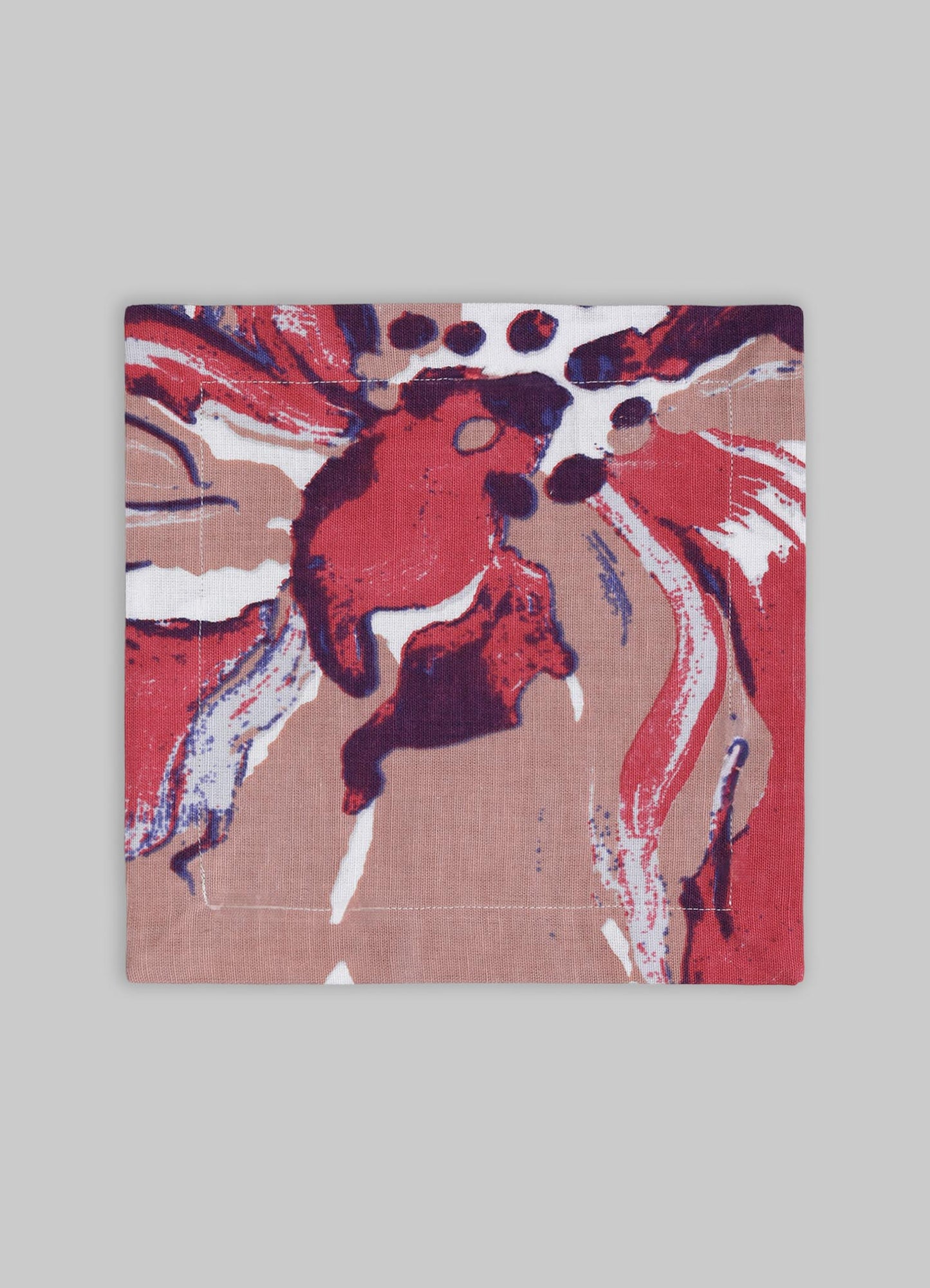 A square textile piece featuring an abstract floral pattern in shades of red, pink, and navy blue on a beige background. The fabric appears to be woven, with a loose and artistic style motif.