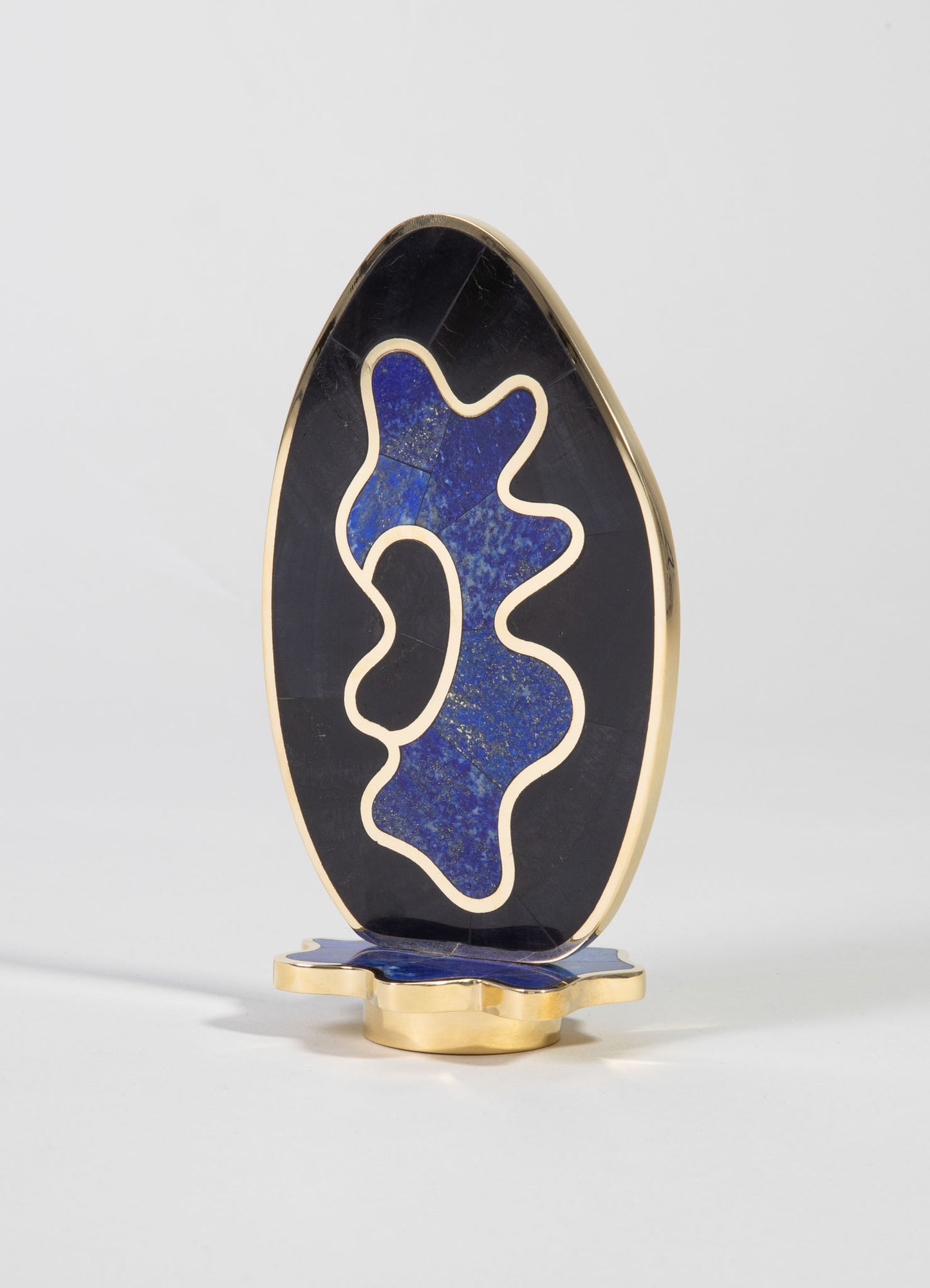 Decorative sculpture with an oval shape, featuring a black and deep blue marbled pattern accented by a gold outline and base, conveying an abstract, contemporary style.