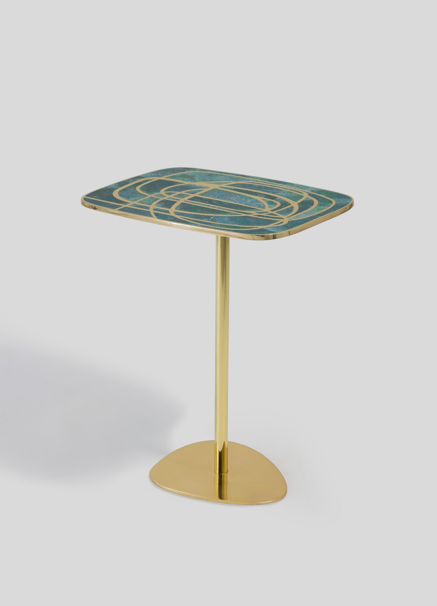 A side table featuring a rectangular top with a geometric pattern in shades of blue and gold, supported by a gold metal stand and rounded base. The design combines contemporary and luxurious styles with metallic accents and abstract motifs.
