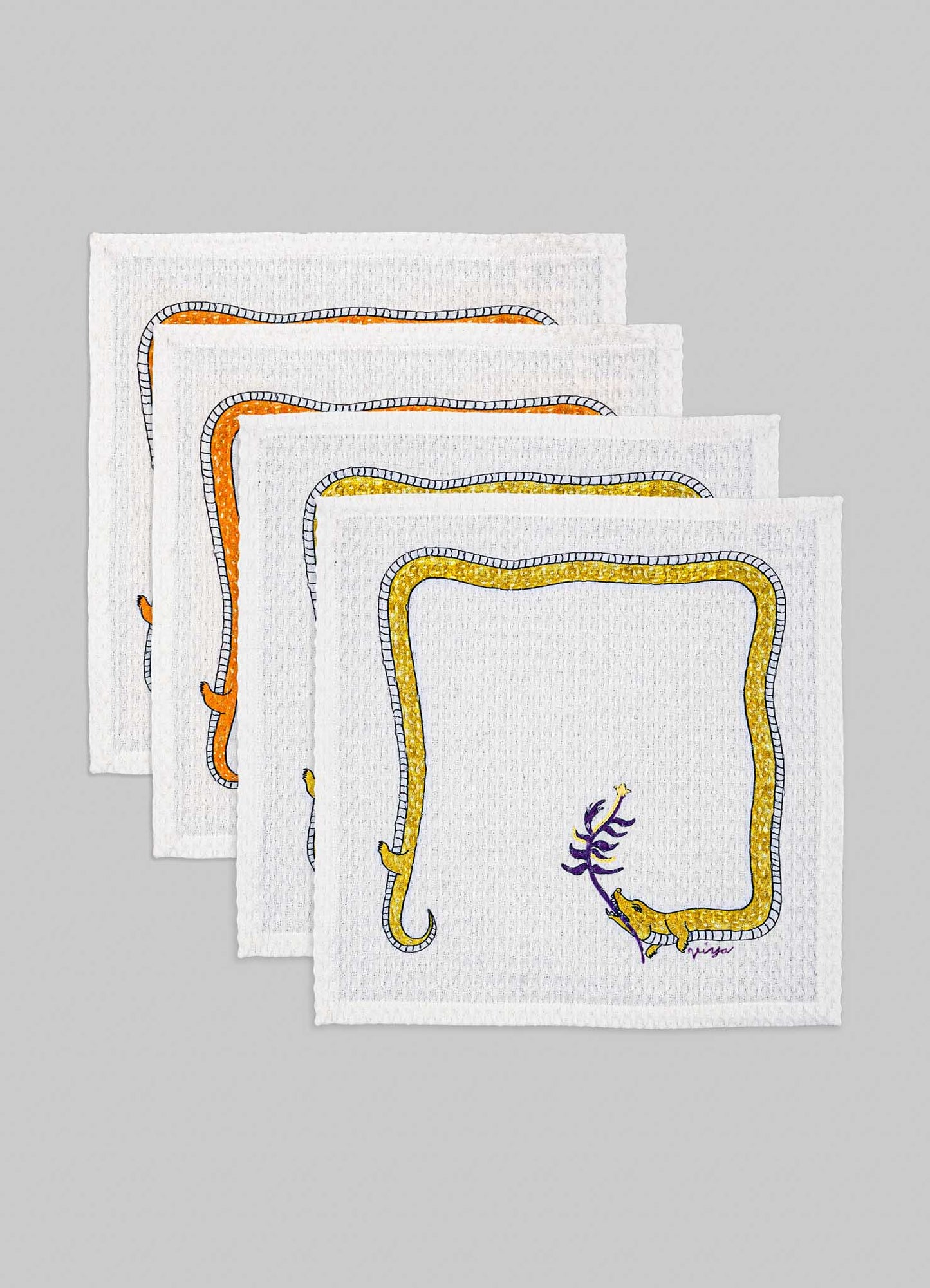 Set of white cloth napkins with colorful embroidered borders in orange, yellow, and purple featuring animal motifs and geometric patterns. The fabric appears to be textured, suitable for table linen or decorative dining accessories.