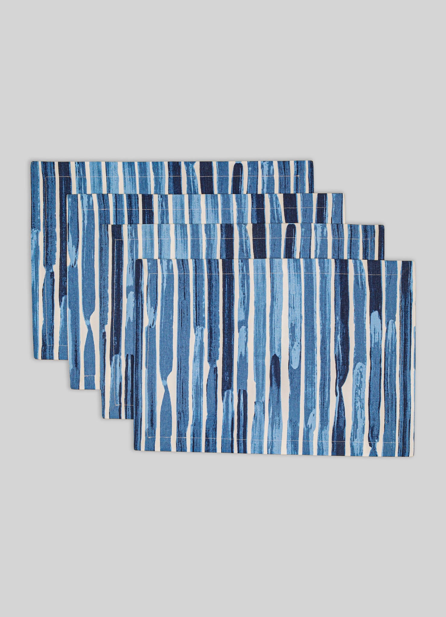Set of four rectangular table runners with a vertical striped pattern in shades of blue and white on a light gray background. Made of fabric with a textured appearance, suitable for contemporary or casual tabletop decor.