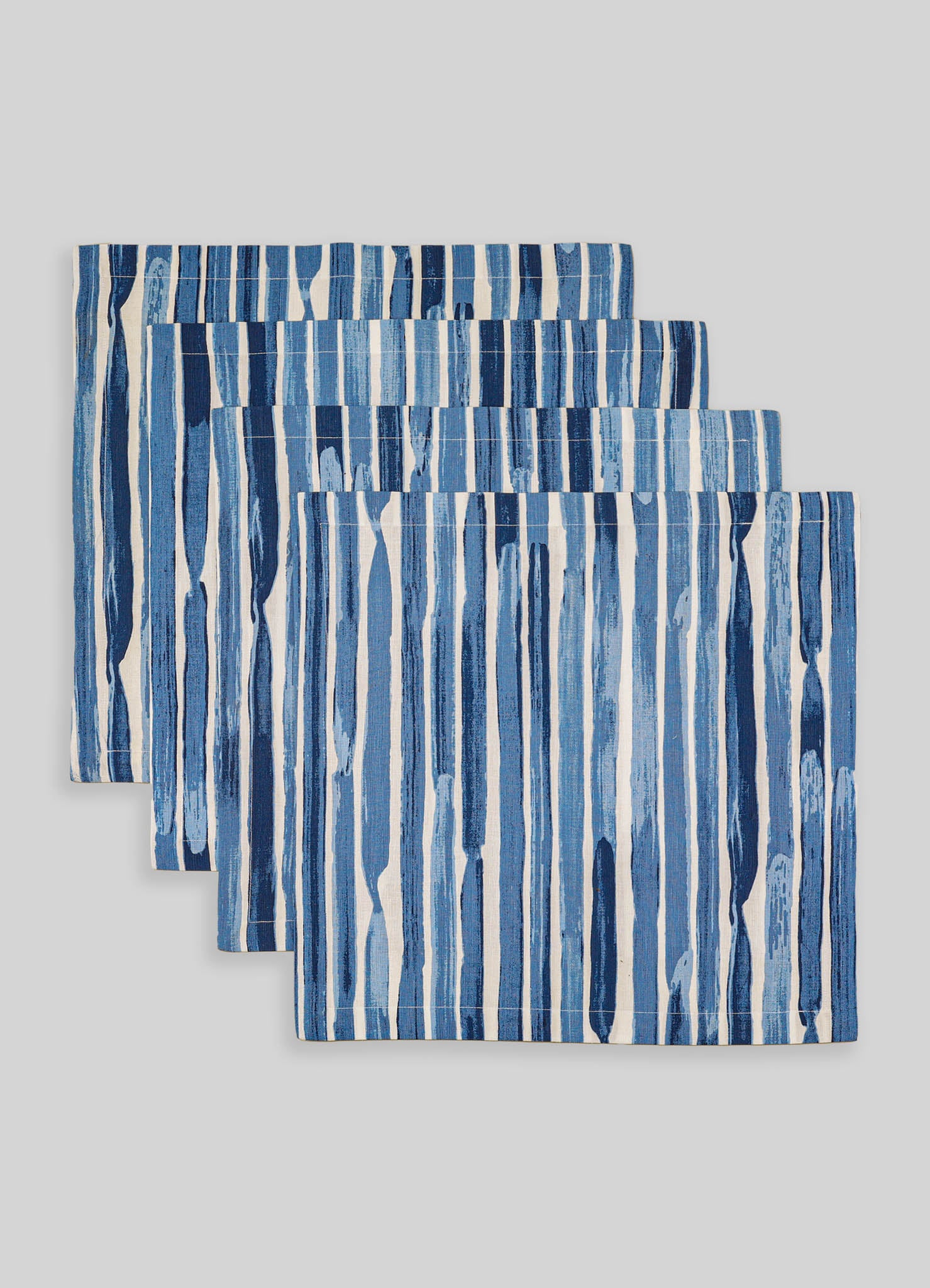Set of three cotton table placemats featuring vertical blue and white abstract stripe patterns, with a contemporary and casual style.