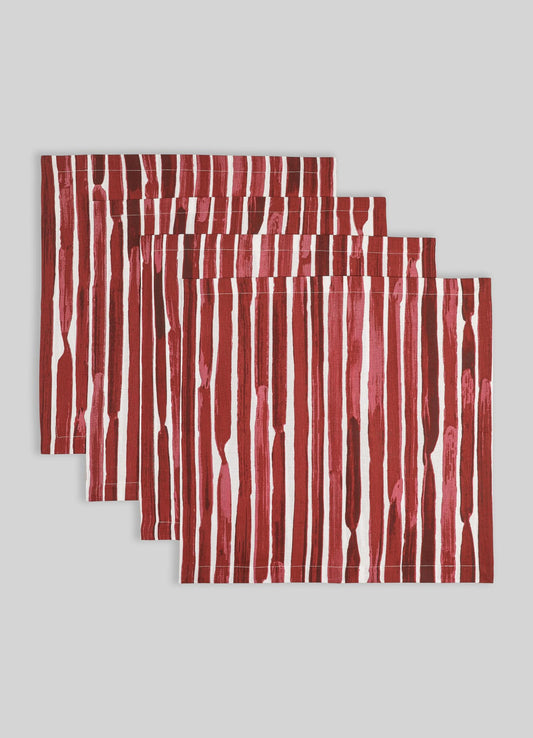 Set of four dinner napkins with bold red and pink vertical stripe pattern, made from cotton fabric.