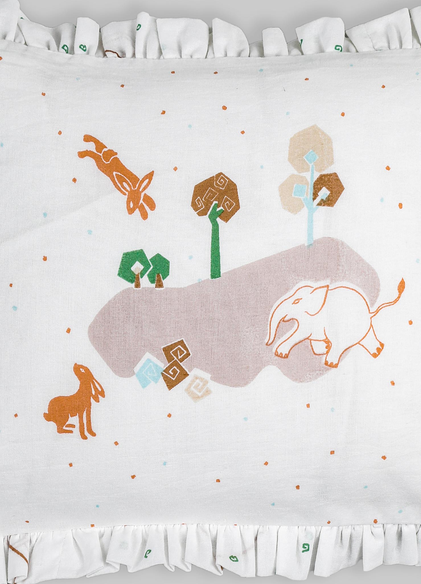 Cotton cushion cover with an embroidered woodland scene featuring animals, trees, and geometric motifs in soft pastel and earthy tones, finished with ruffled trim around the edges.