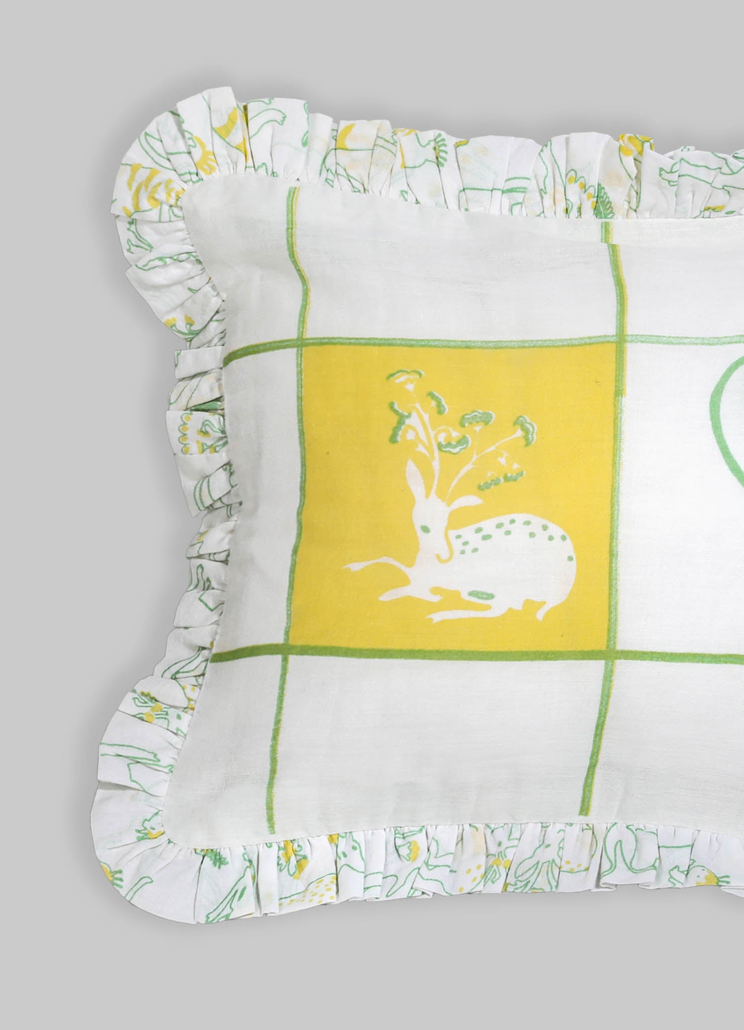 Cotton cushion with a printed yellow and green illustration of a rabbit and flowers, featuring a ruffled edge with a coordinating floral and animal motif.