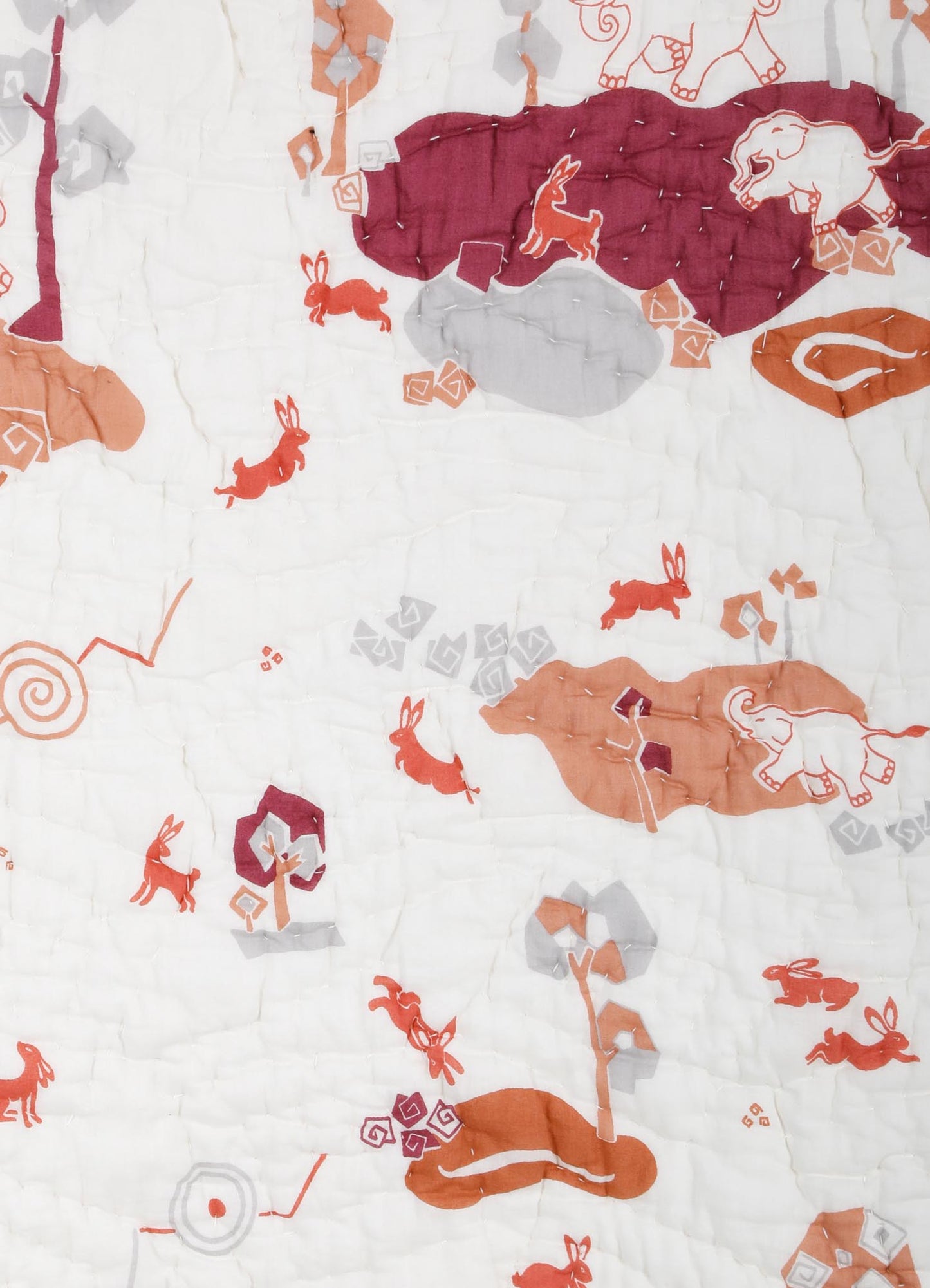 Quilt with printed animal motifs, featuring elephants, rabbits, and other creatures in shades of orange, pink, and gray on a white background. The fabric appears lightweight and textured, suitable for decorative or bedding use.