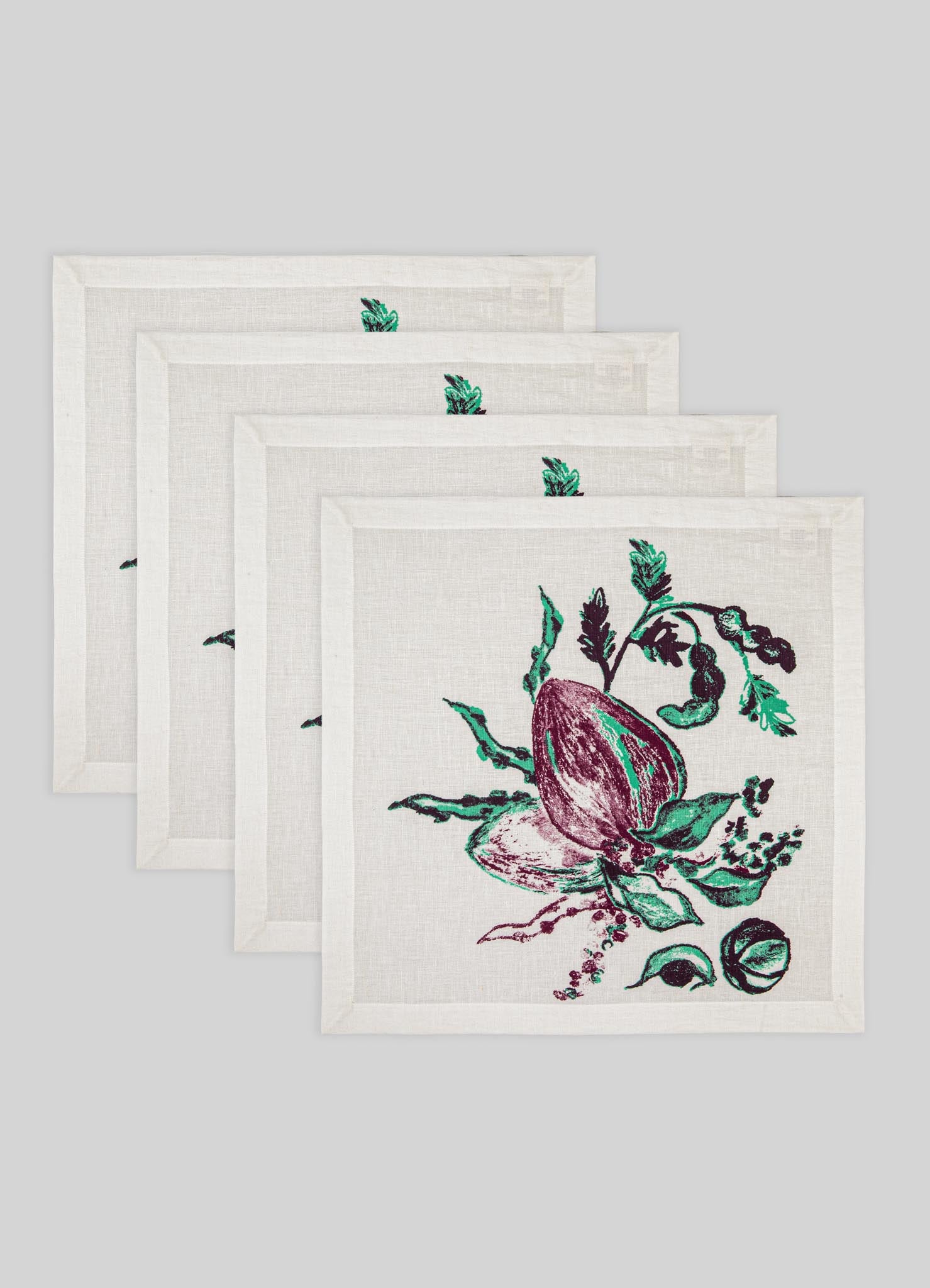 Set of four white cotton or linen napkins featuring hand-printed botanical illustrations in dark green and purple tones, with stitched borders. The design has a vintage, handcrafted style suitable for rustic or contemporary tableware.