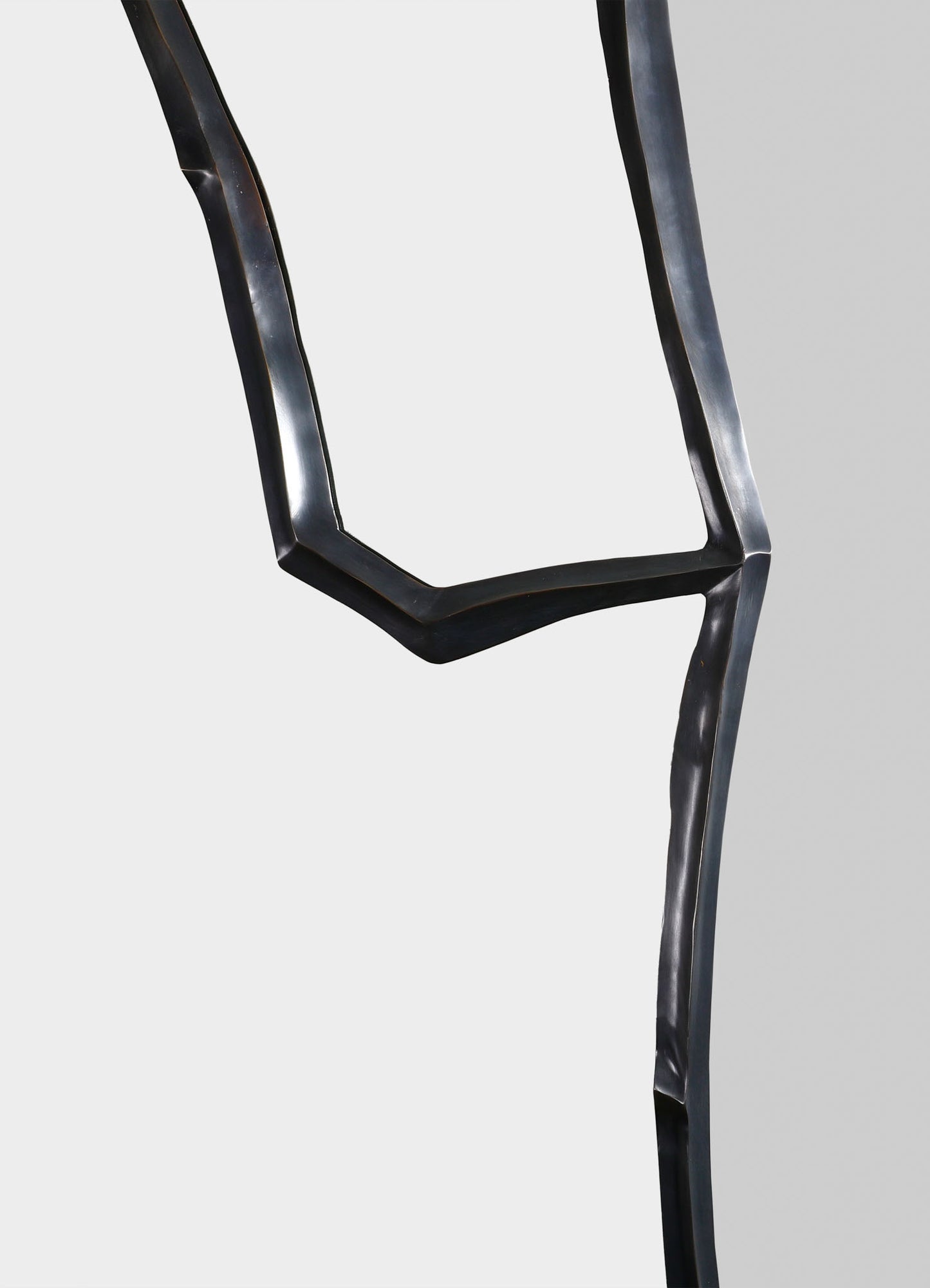 Metallic black chair with a sculptural, wavy design and a matte finish, featuring angular lines and a contemporary style.