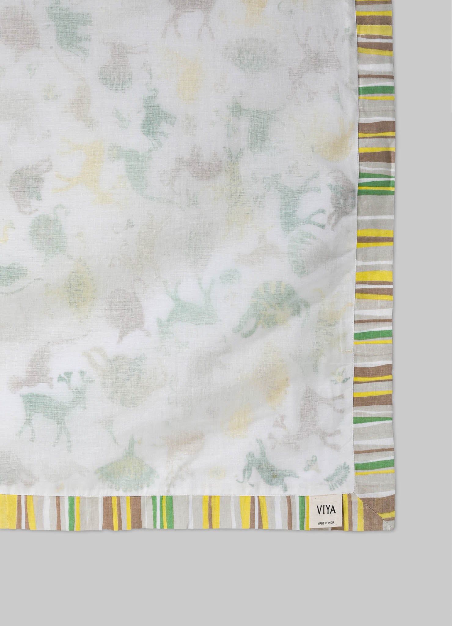 Cotton handkerchief with a subtle floral pattern in pastel shades, bordered by multicolored striped trim in yellow, green, brown, and white. The fabric has a light, airy texture with a small label indicating "VIYA" and "Made in India."