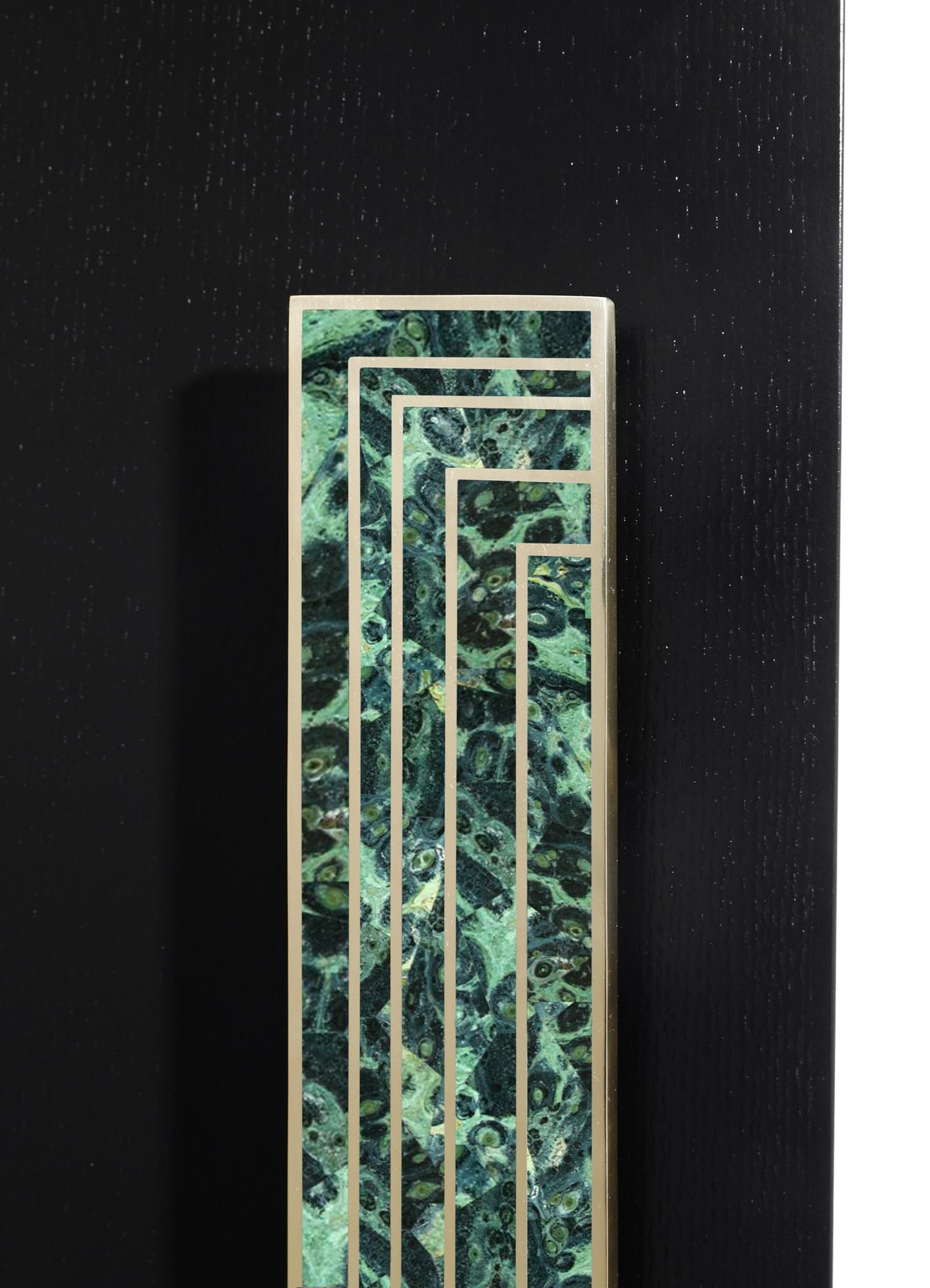 A decorative screen with a geometric metal frame and a marbled green glass background, set against a black textured wall.