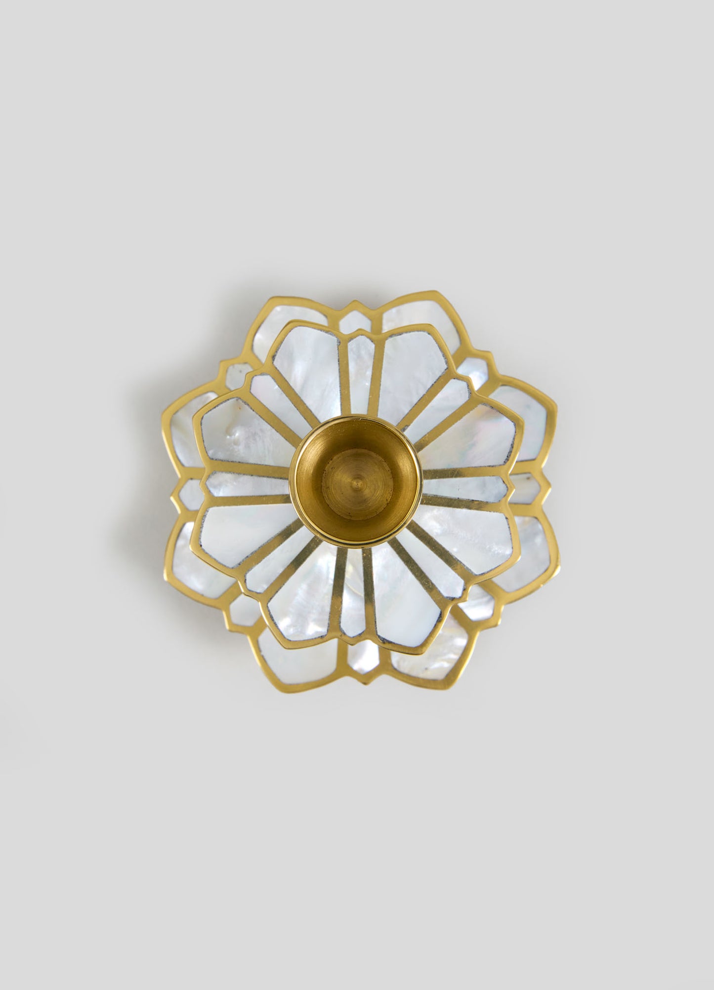 A ceiling light fixture featuring a gold metal frame and a floral-inspired design with petal-shaped components, accented by iridescent mother-of-pearl or shell-like panels. The fixture has a central brass or gold-tone socket for a bulb.