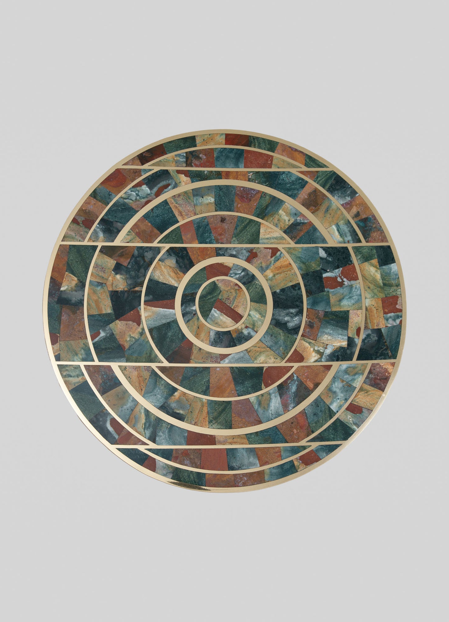 A decorative mosaic tray with concentric circular patterns made of colorful stone tiles in shades of green, brown, and blue, framed with thin metallic borders. The tray has a contemporary design with a geometric motif.