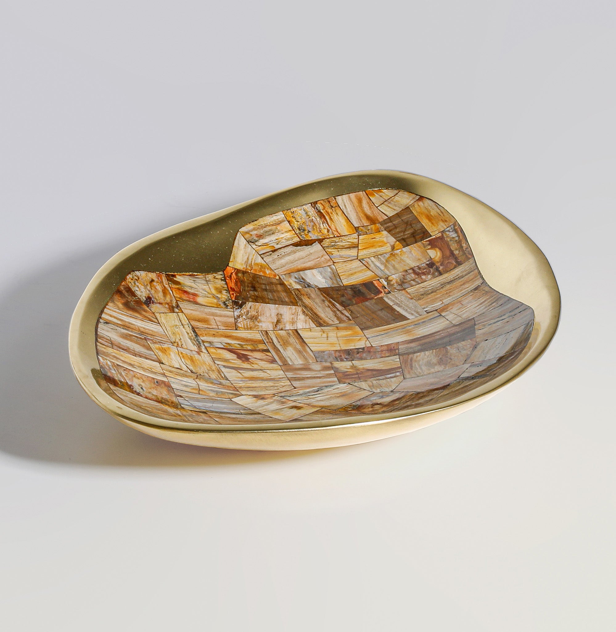 Oval ceramic or porcelain dish with a beige or light cream exterior, featuring a mosaic pattern in warm earthy tones including browns, oranges, and tans. The dish has a smooth, glossy surface and a shallow, slightly curved shape suitable for serving or decorative display.