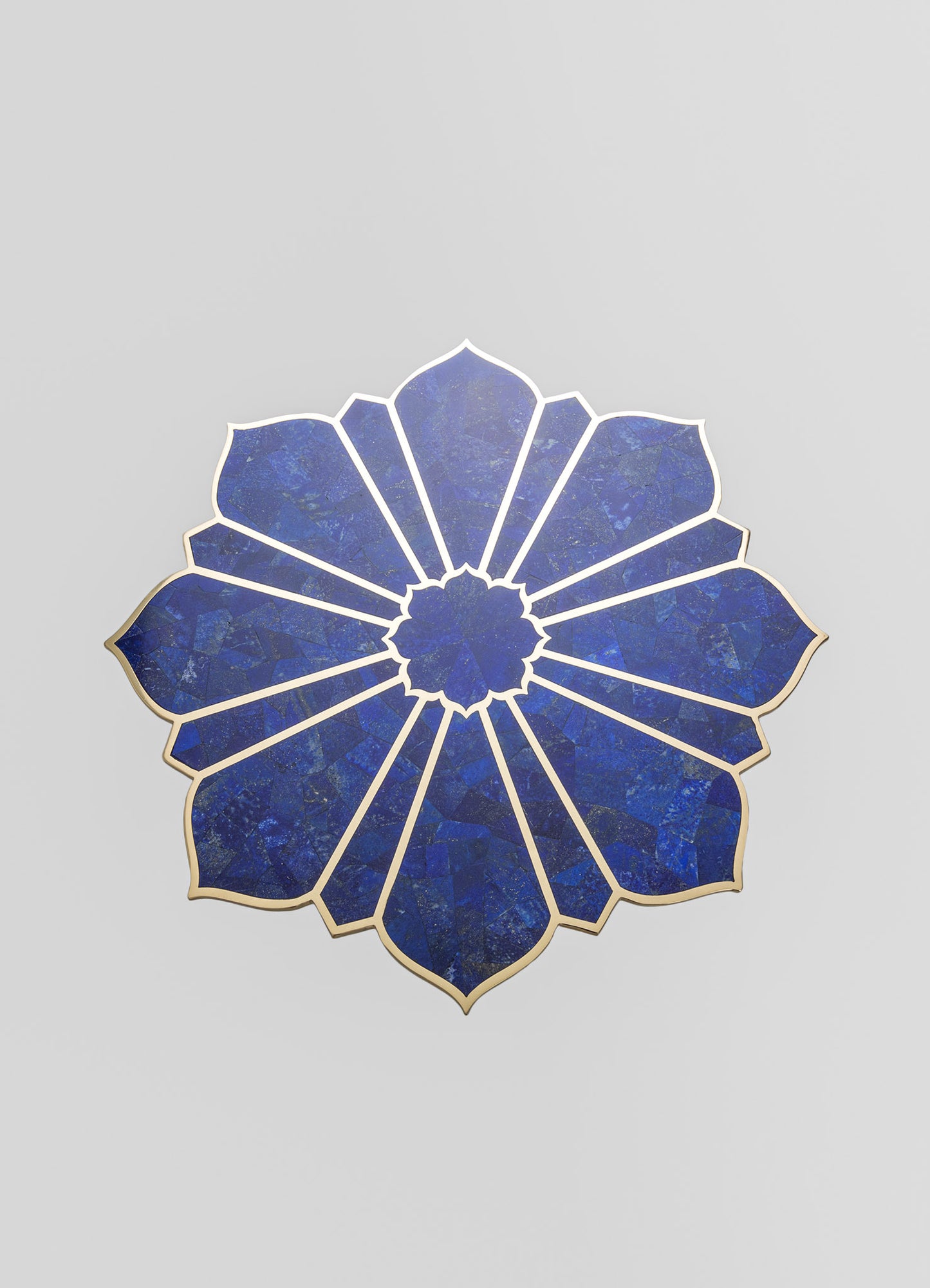 Decorative wall mirror with a floral-inspired design, featuring a deep blue mosaic pattern and a metallic gold frame, set against a plain light gray background.