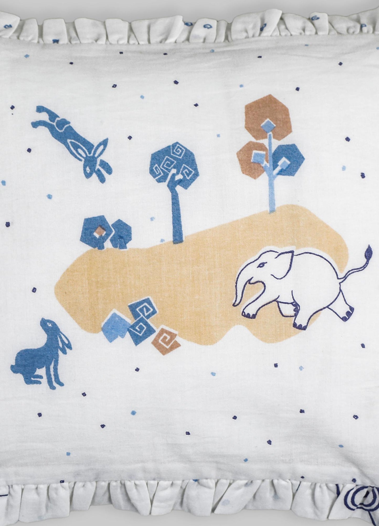 Cotton bed cover featuring a whimsical animal and nature motif with elephants, rabbits, trees, and flying creatures in shades of blue, beige, and brown. The design includes simple, stylized patterns with a ruffled edge trim.