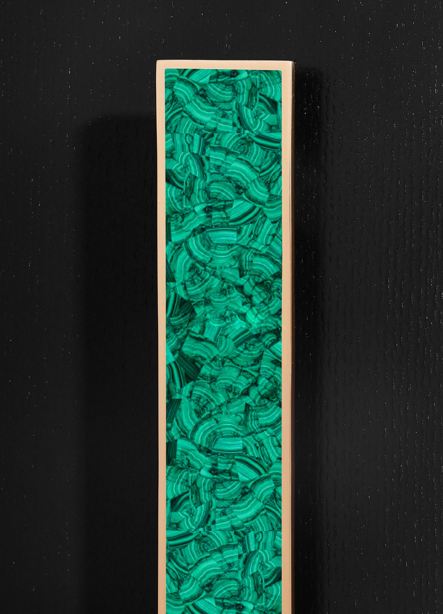 A tall, rectangular jewelry box with a glossy, green malachite-patterned surface encased in a light-colored frame, focused on luxury and elegant design.
