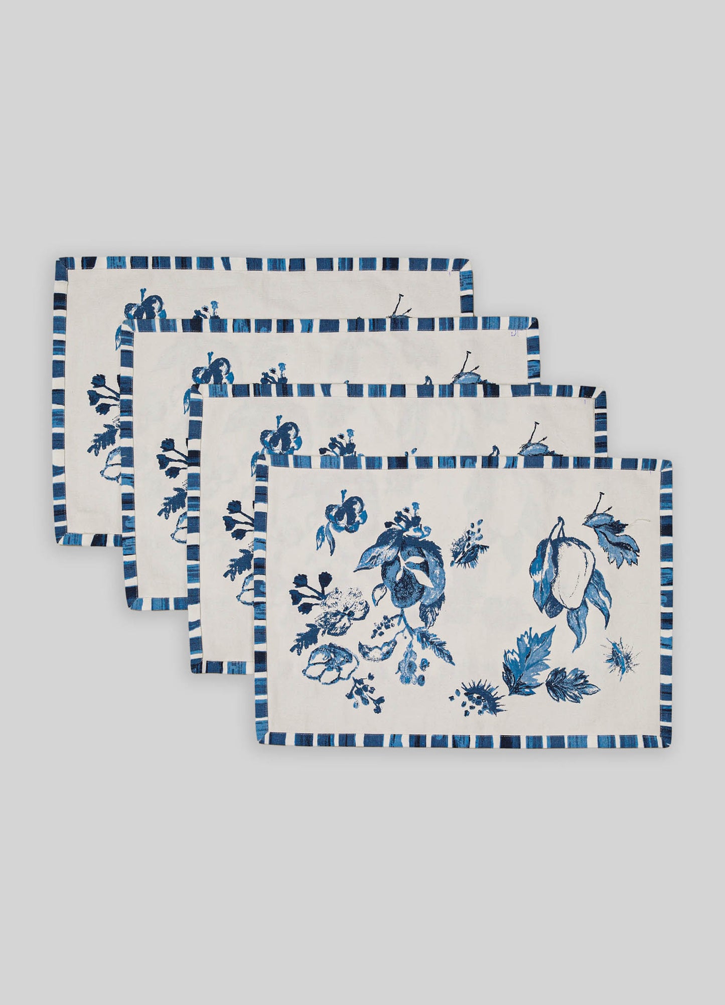 Set of four cotton napkins with blue floral and geometric pattern, featuring a striped border in shades of blue and white.