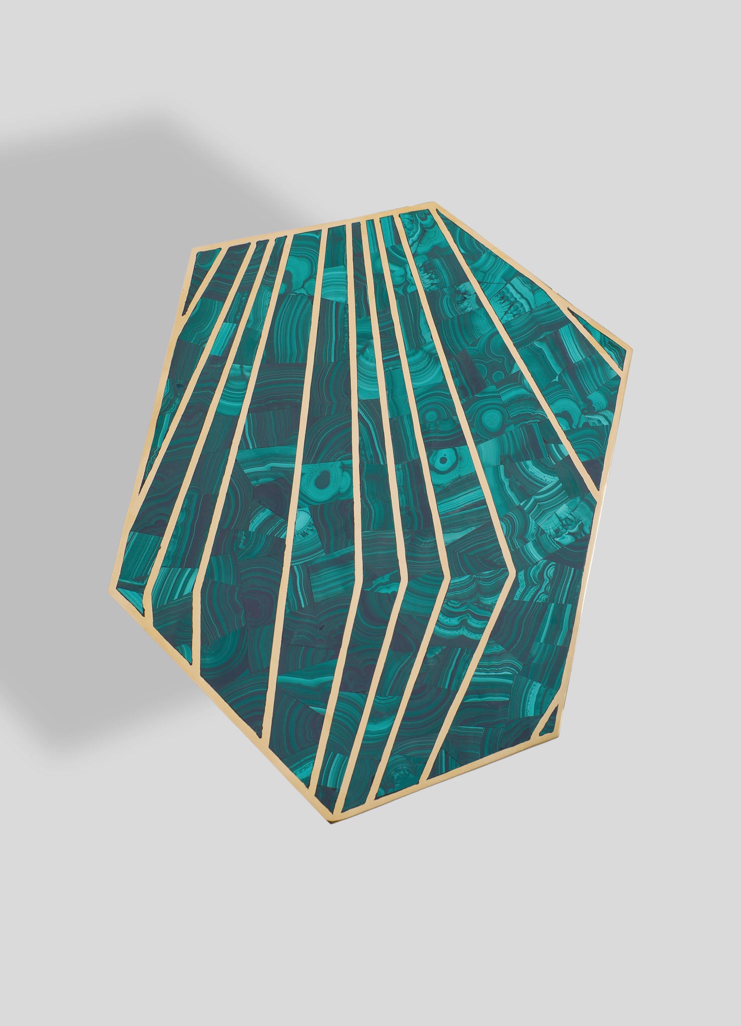 A geometric side table with a hexagonal shape, featuring a marbled turquoise and blue pattern on the surface and a light wood frame, creating a contemporary and artisanal look.