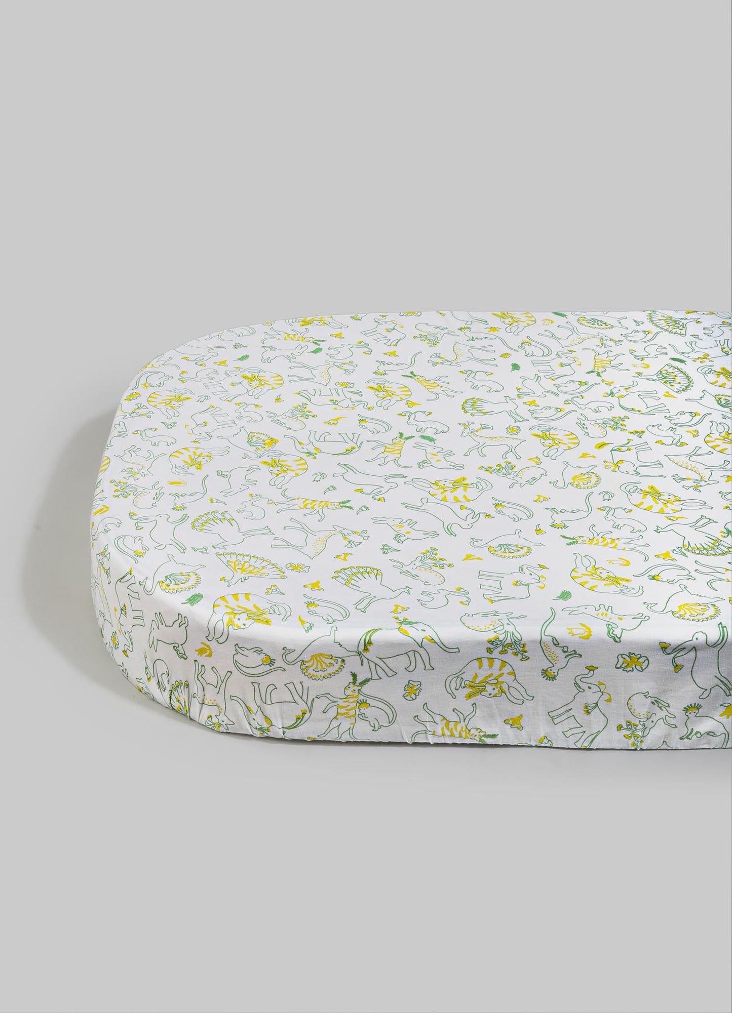 A fitted bed sheet with a playful animal print pattern featuring outlines of various animals in yellow and green on a white background. The fabric appears smooth and lightweight, suitable for children's or casual bedding.