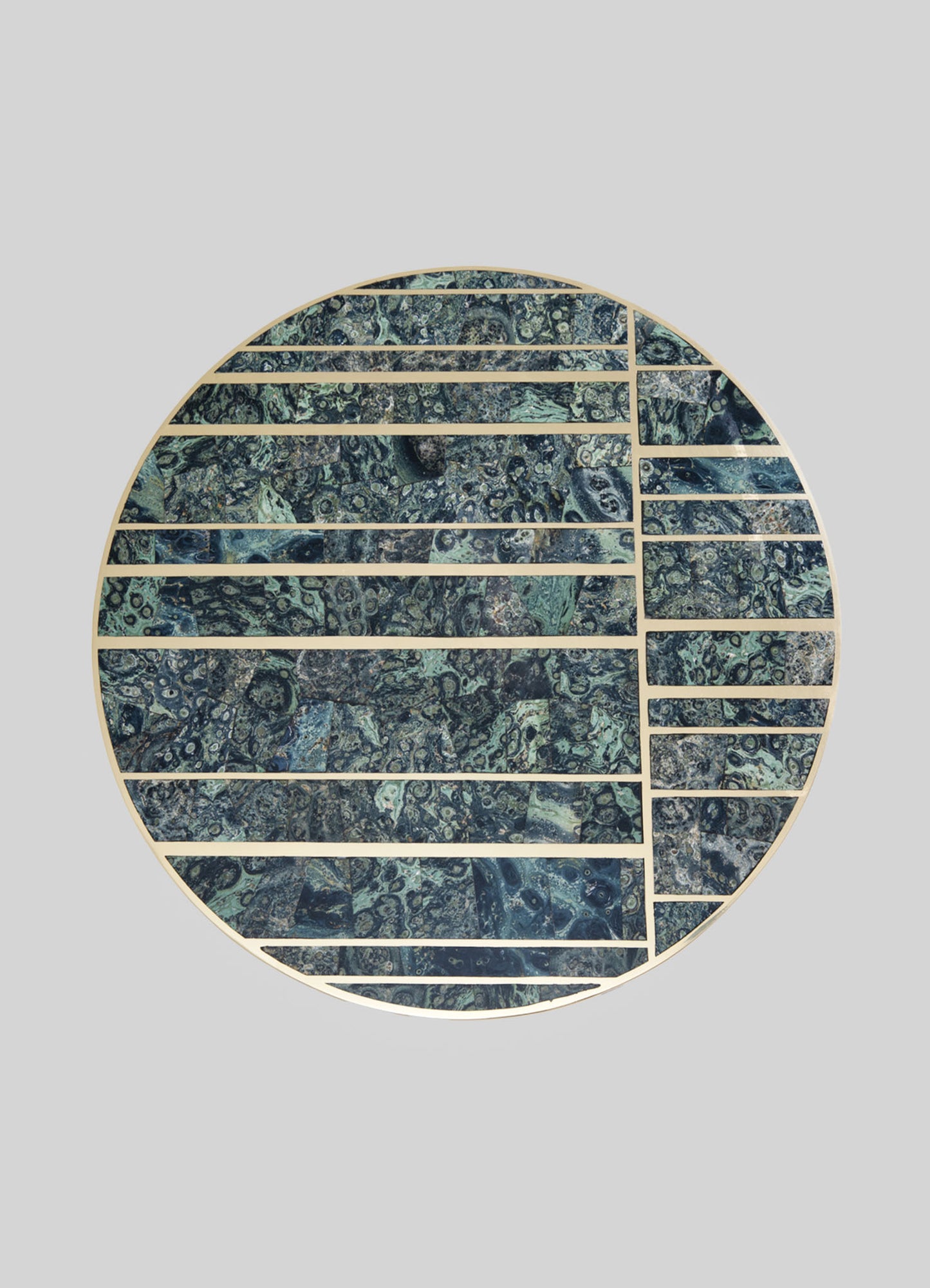 A round decorative wall panel with a mosaic pattern in shades of blue, green, and gray, framed by narrow wooden strips creating divided sections. The design features a mix of organic, swirling motifs and textured stone-like surfaces.