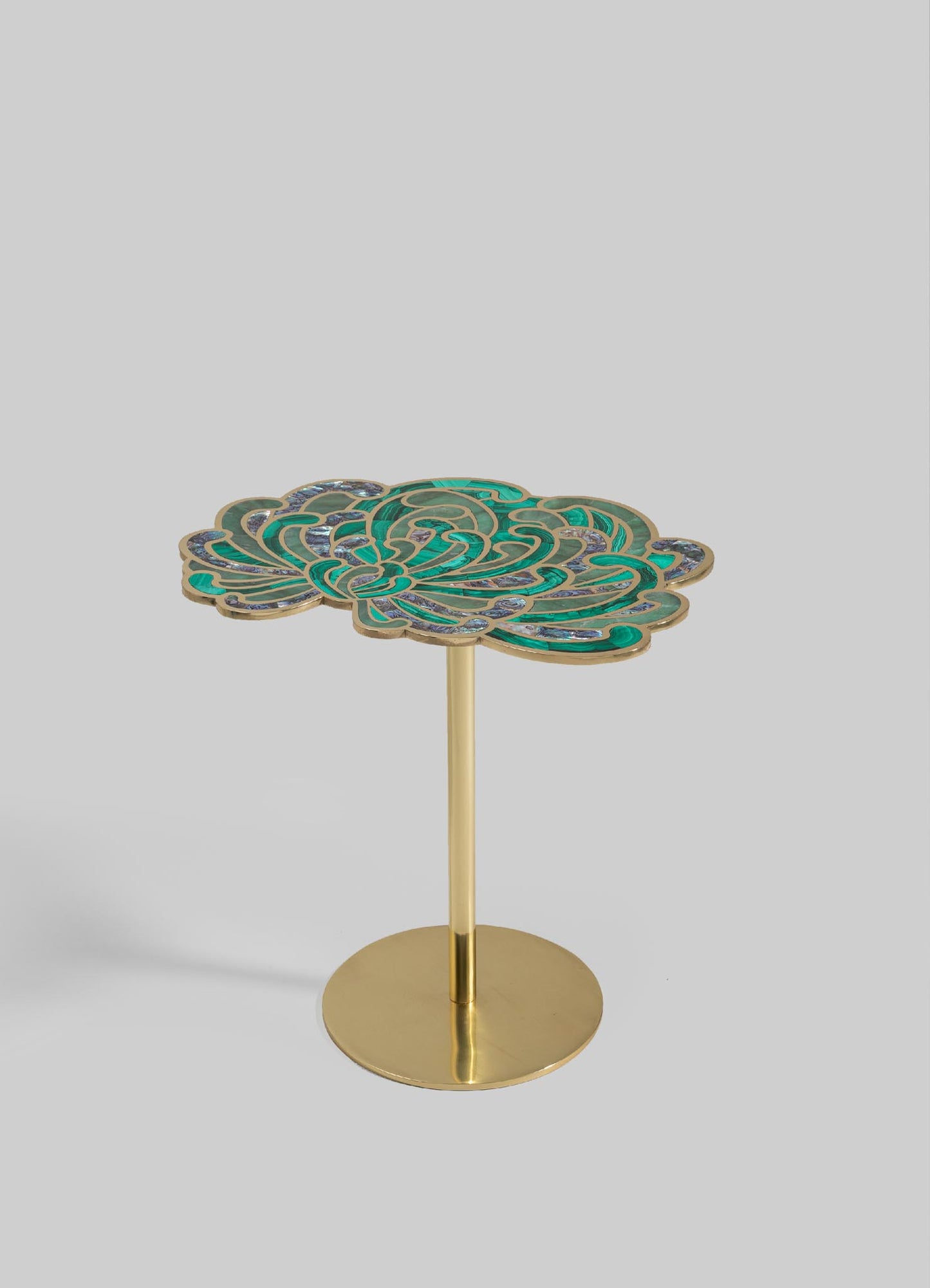 A decorative side table with a floral motif featuring enamel in teal and blue tones, framed with gold-colored metal. The table has a round, flat base and a slender cylindrical stand supporting the elaborately designed top.