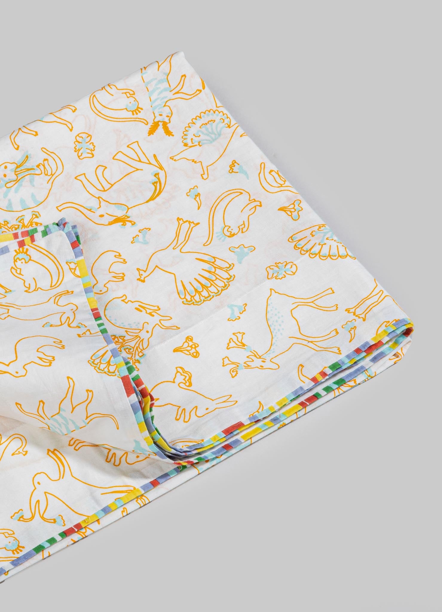 Cotton bedsheet with a colorful animal print pattern featuring outlined illustrations of various animals in orange and light blue, bordered with a multicolored striped edge.