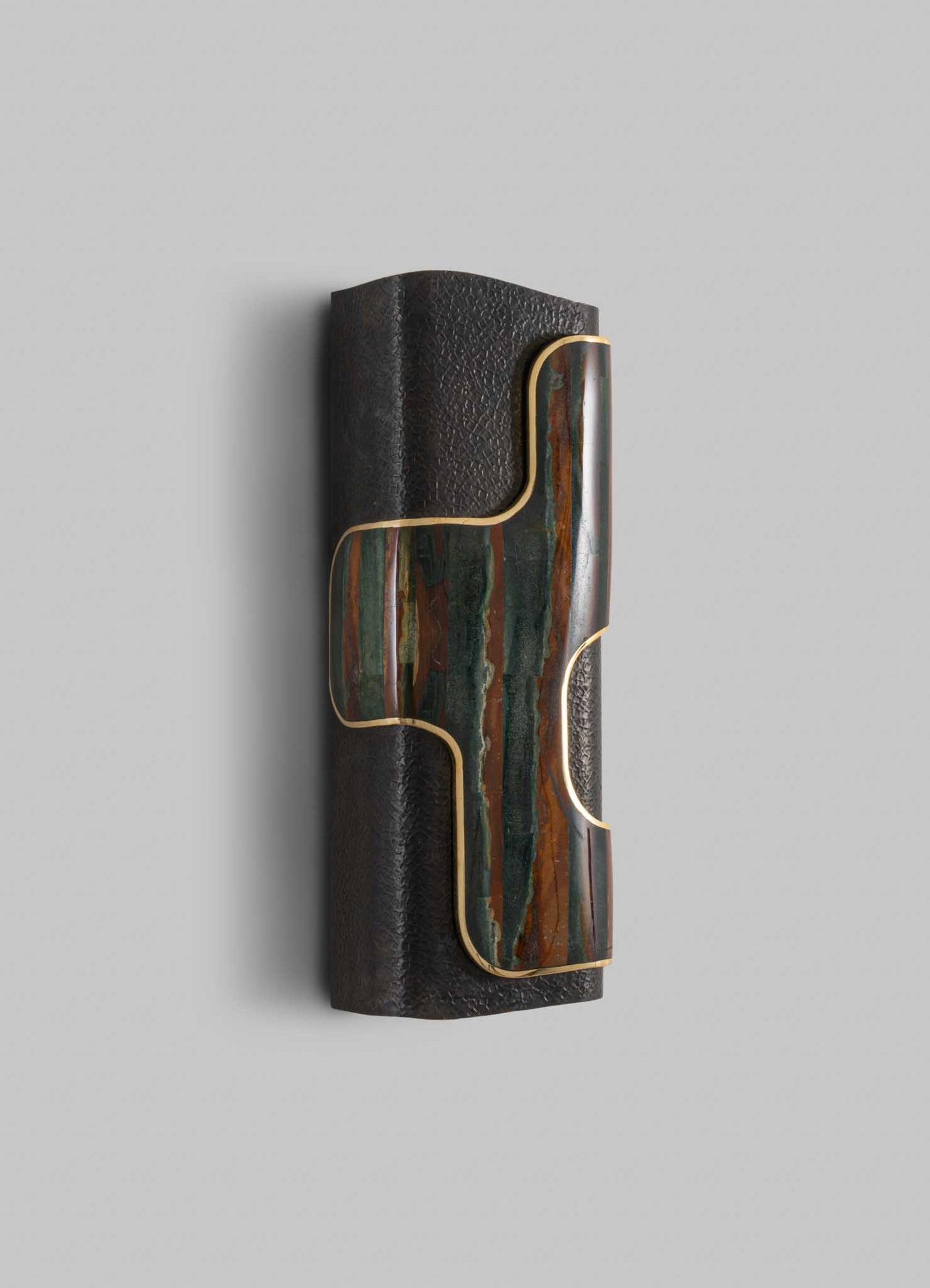 A wall-mounted lamp with a cylindrical black textured metal base and a multicolored marble inlay accentuated by a gold trim, combining contemporary and luxurious design elements.