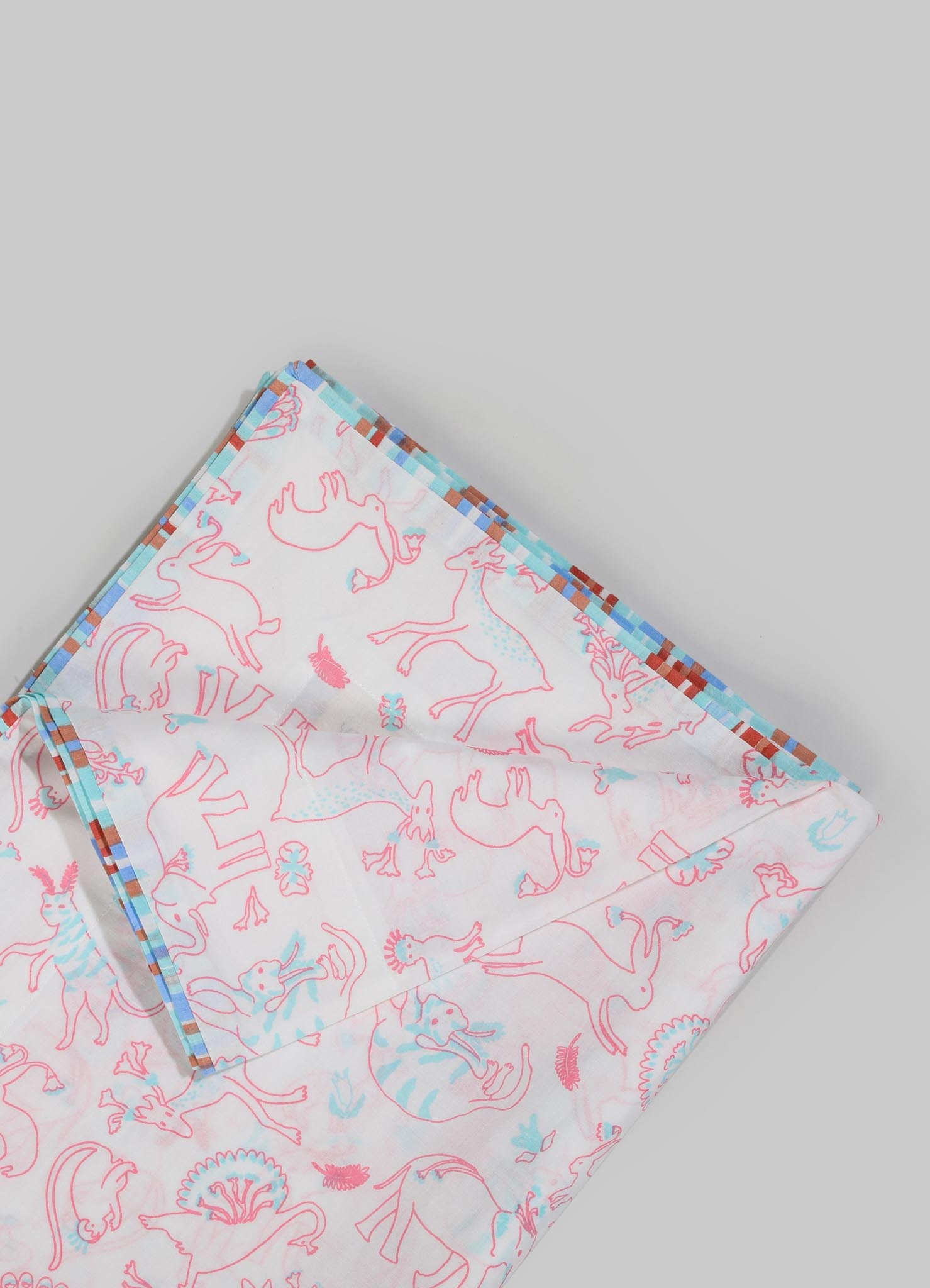 Printed fabric with a pattern of outlined mythological creatures and floral motifs in pink and blue tones, accented with a checkered border in red, blue, and brown. The fabric appears lightweight, possibly cotton or a similar material.