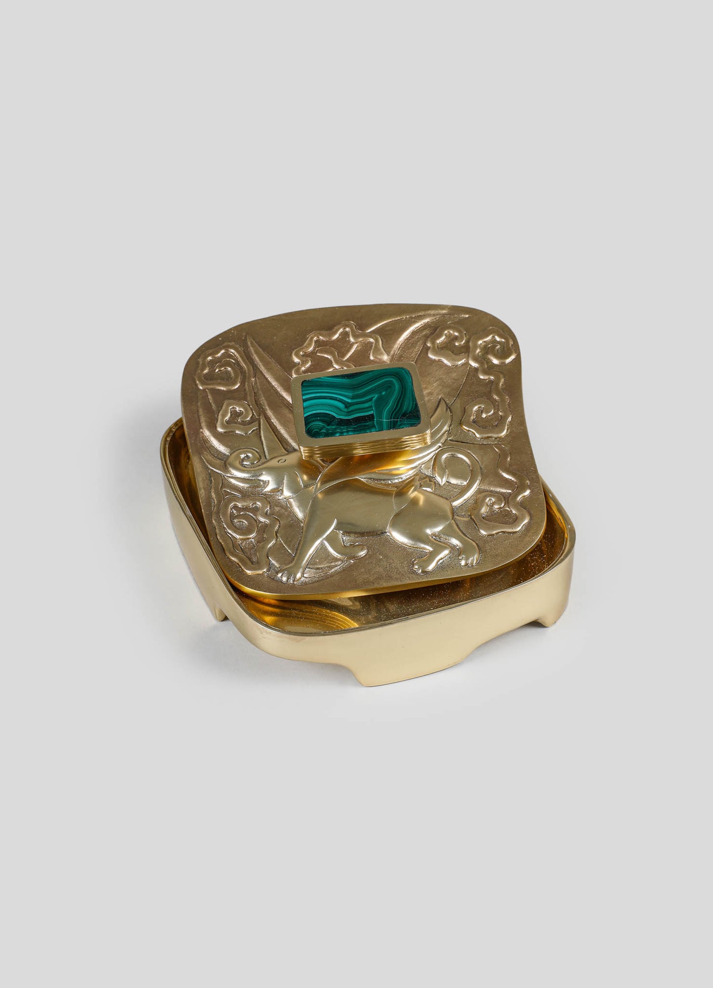 A decorative jewelry box made of metal with an embossed floral and animal motif, featuring a rectangular malachite stone on the lid. The box has a gold-tone finish and a squarish shape with rounded edges.