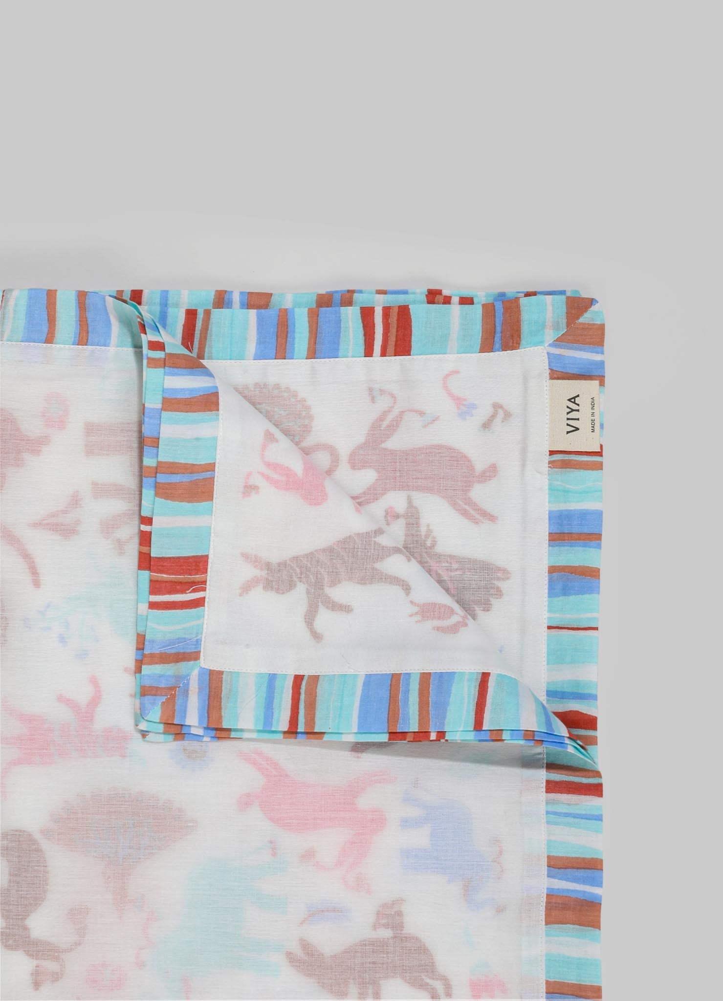 Cotton bedsheet with a multicolored striped border and a printed animal motif featuring pink and gray silhouettes of birds, insects, and other creatures. The fabric has a soft, light tone with a contemporary and playful design.
