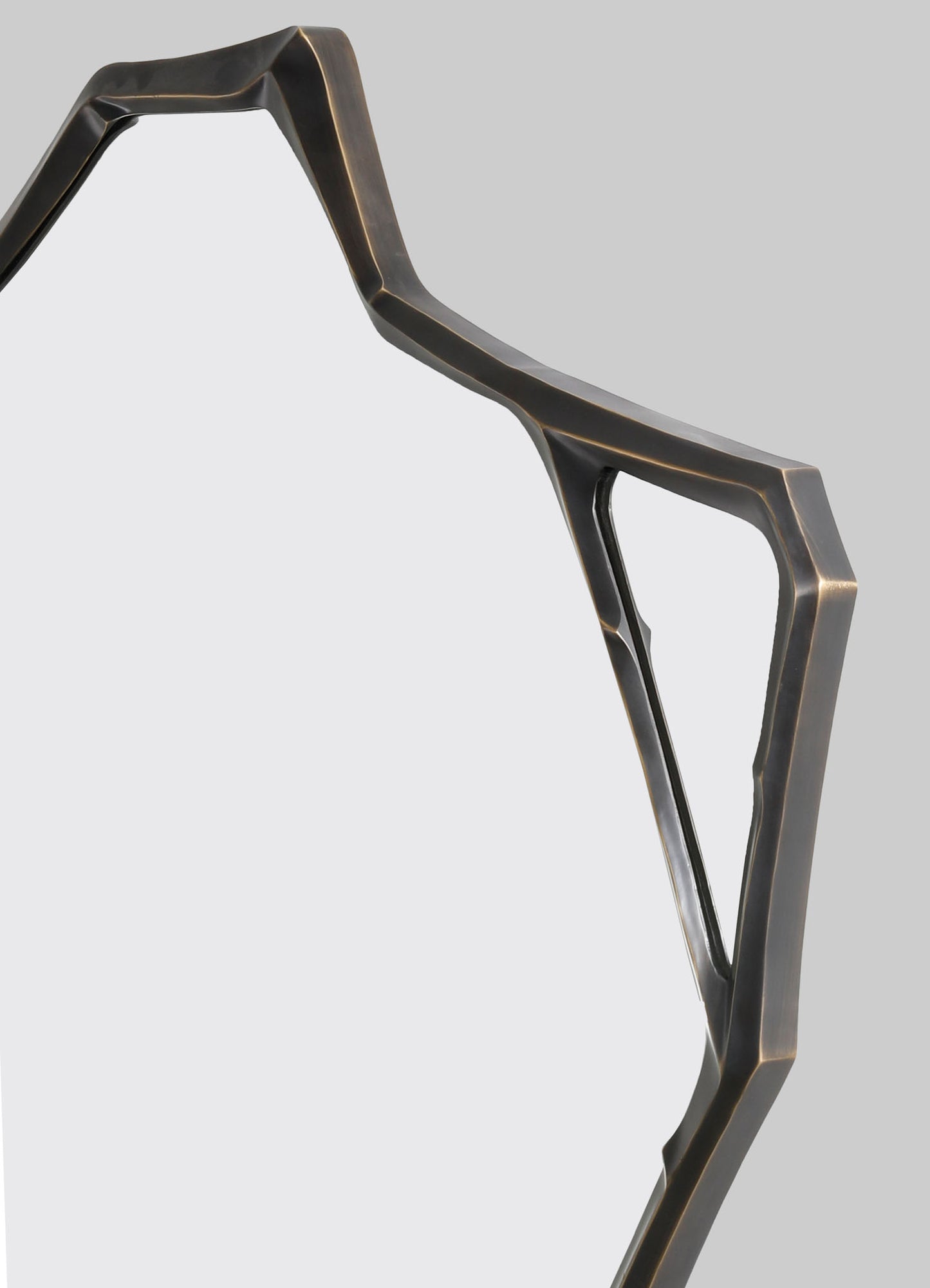 A geometric metal frame in a dark, brushed finish, featuring angular lines and open sections, likely part of a modern-style furniture or decorative object.