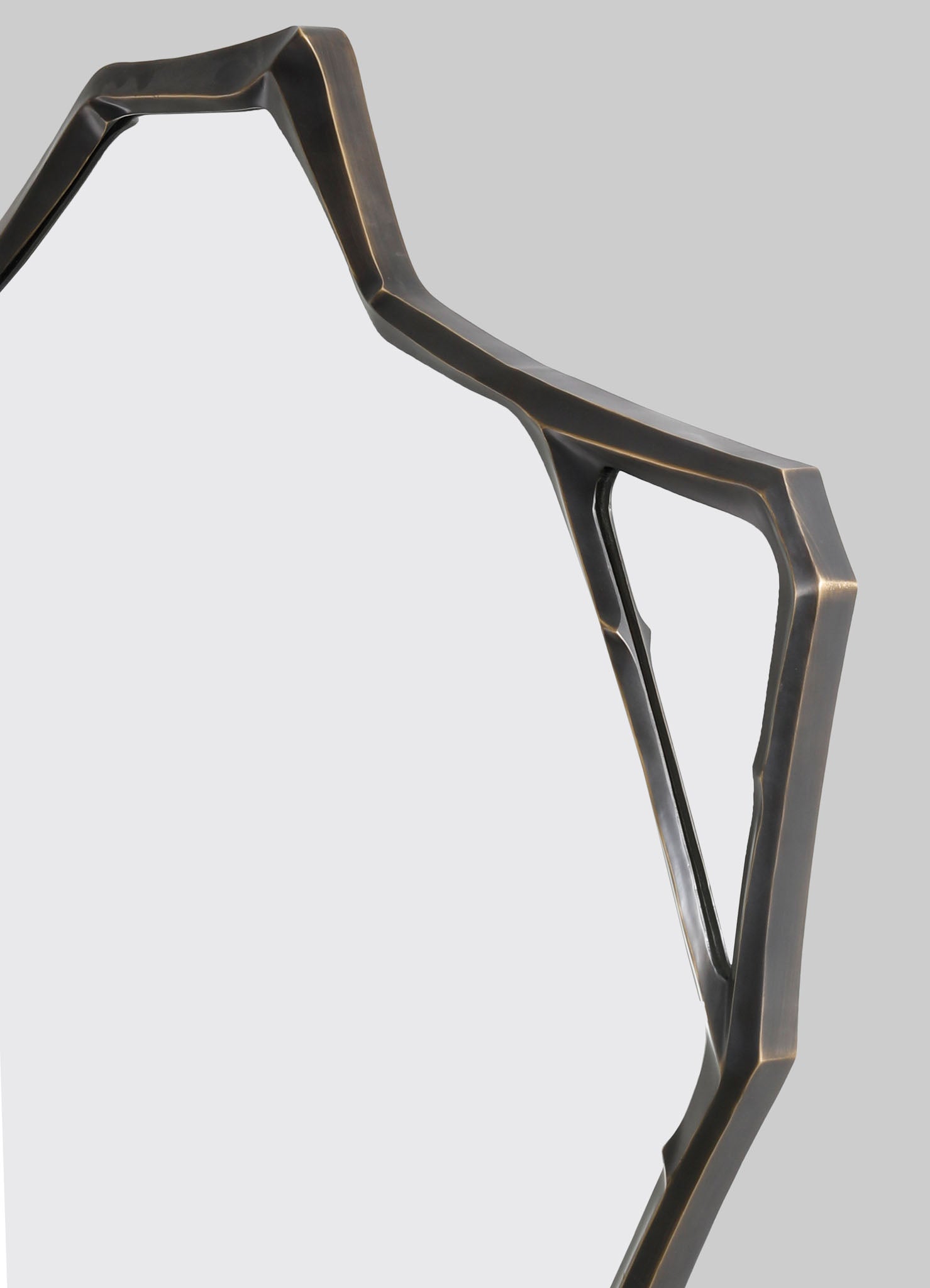 A geometric metal frame in a dark, brushed finish, featuring angular lines and open sections, likely part of a modern-style furniture or decorative object.