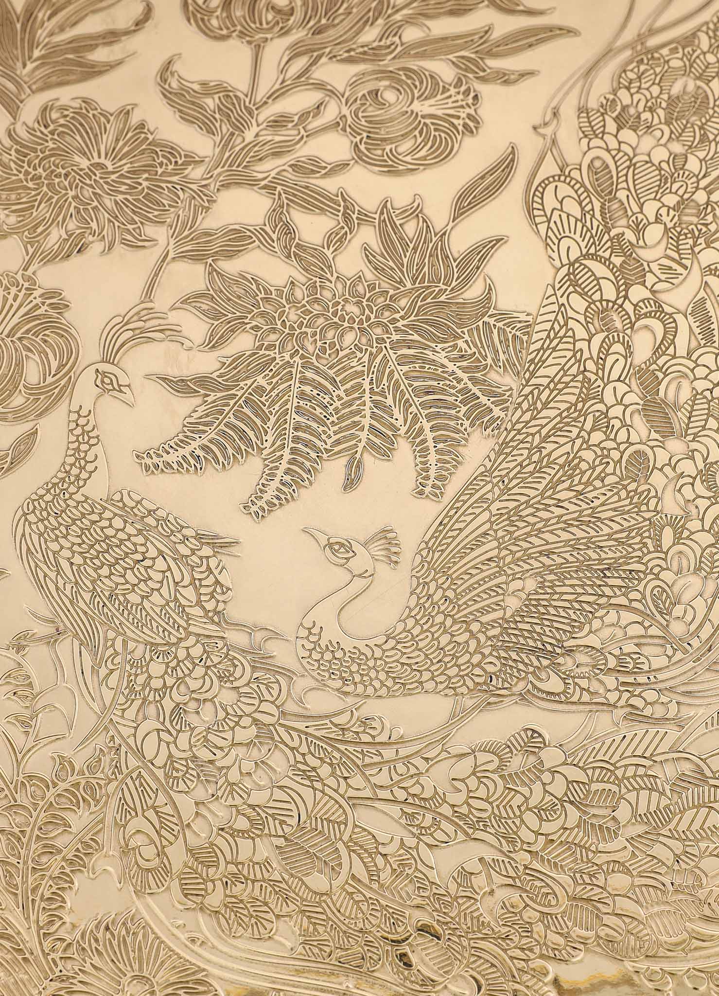 Decorative gold-embossed paper with intricate floral and peacock motifs, featuring detailed line patterns and a luxurious, handcrafted style.