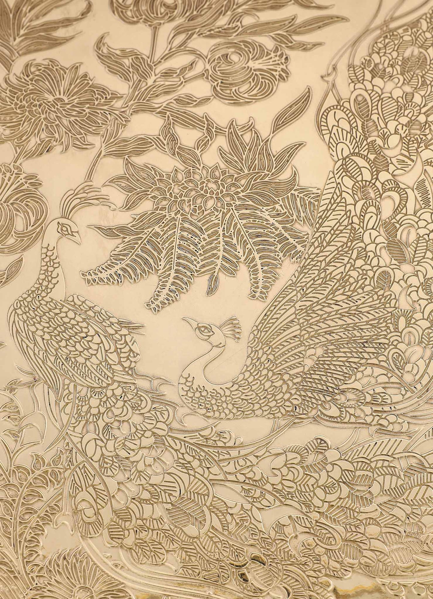 Ornate beige and gold embossed textile featuring intricate floral, peacock, and foliage motifs in a traditional design style. The pattern showcases detailed linework with a luxurious and decorative appearance.