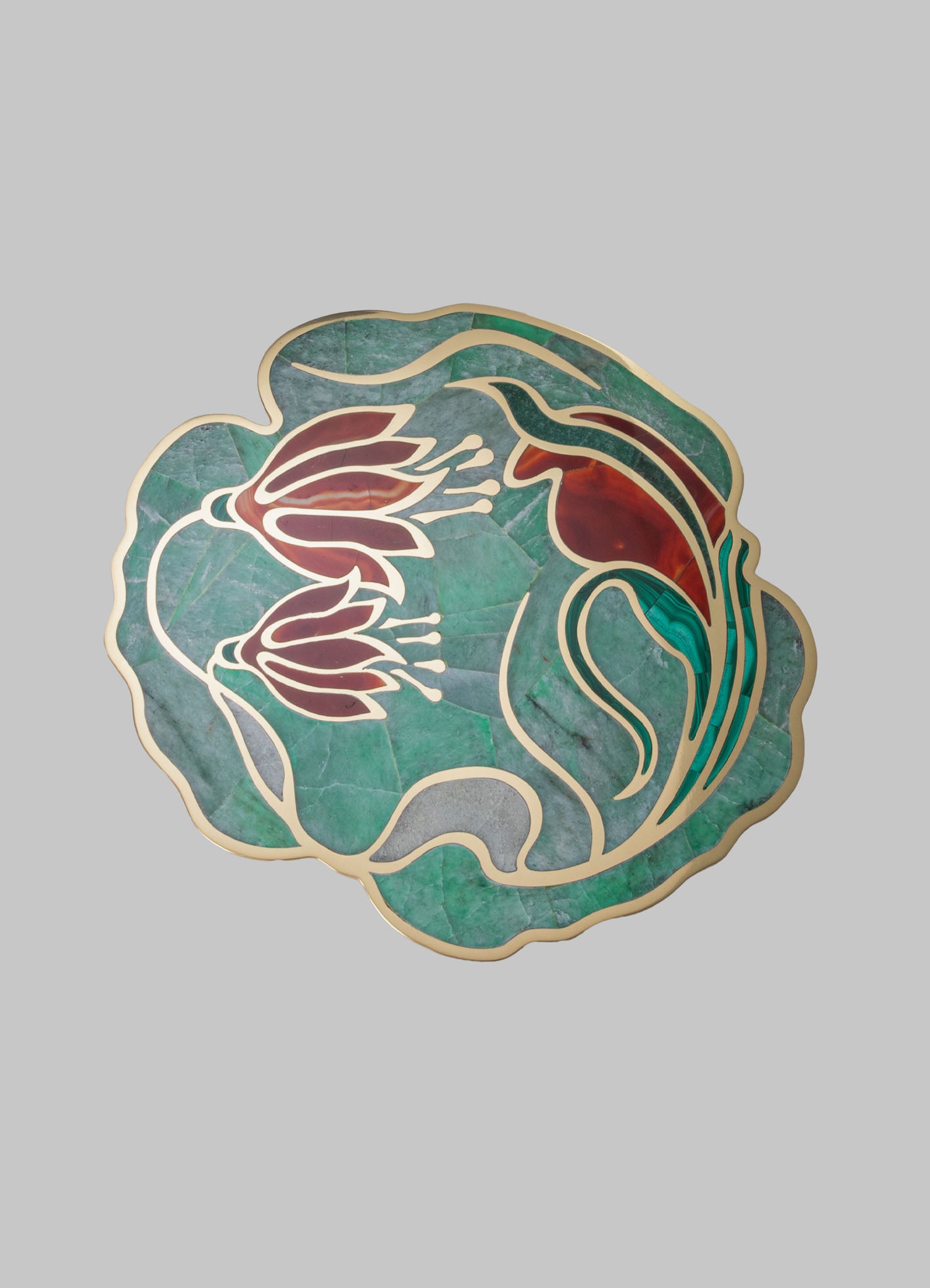Decorative stained glass wall art featuring a floral motif with red and green colored glass pieces outlined in metallic trim, set against a plain background.