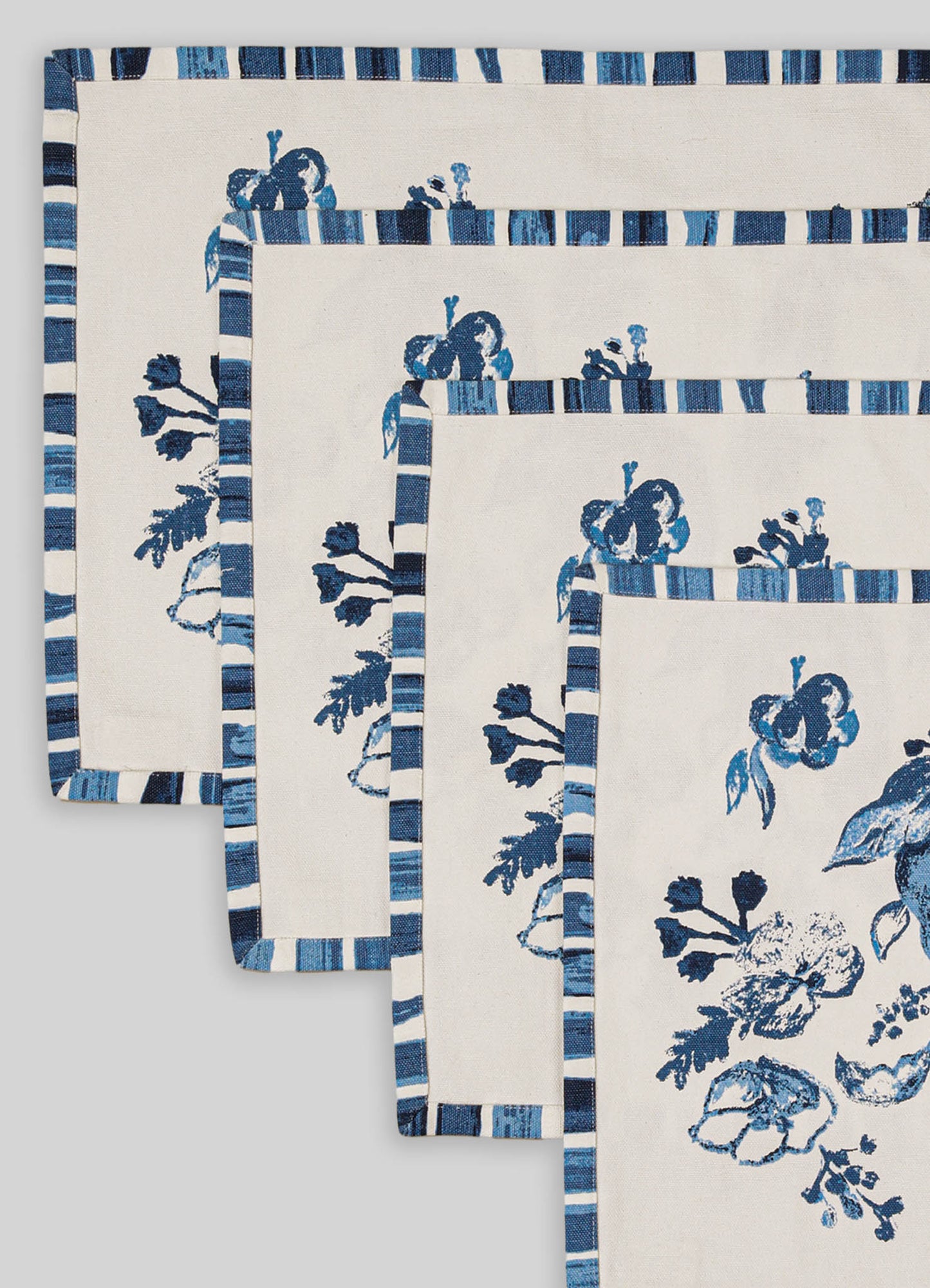 Linen table runners with blue floral motifs and striped borders in shades of blue and white, designed for table decor.