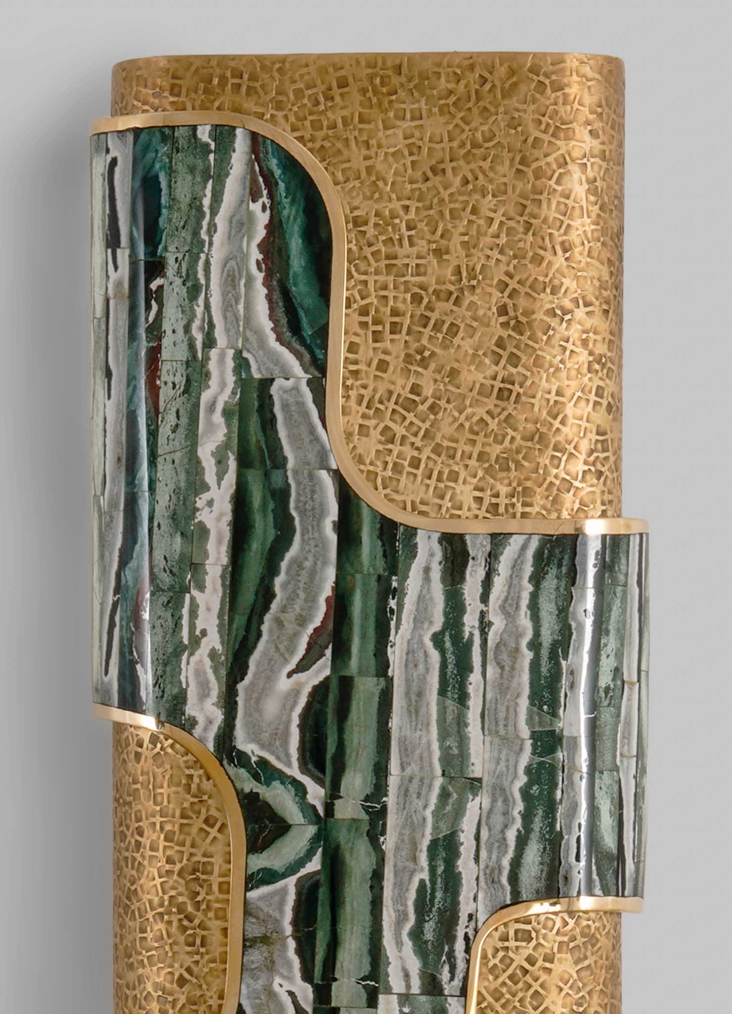 A decorative side table featuring a combination of green and white marble with organic veining, complemented by gold accents and a lattice pattern in a warm wood finish, creating a contemporary and luxurious look.