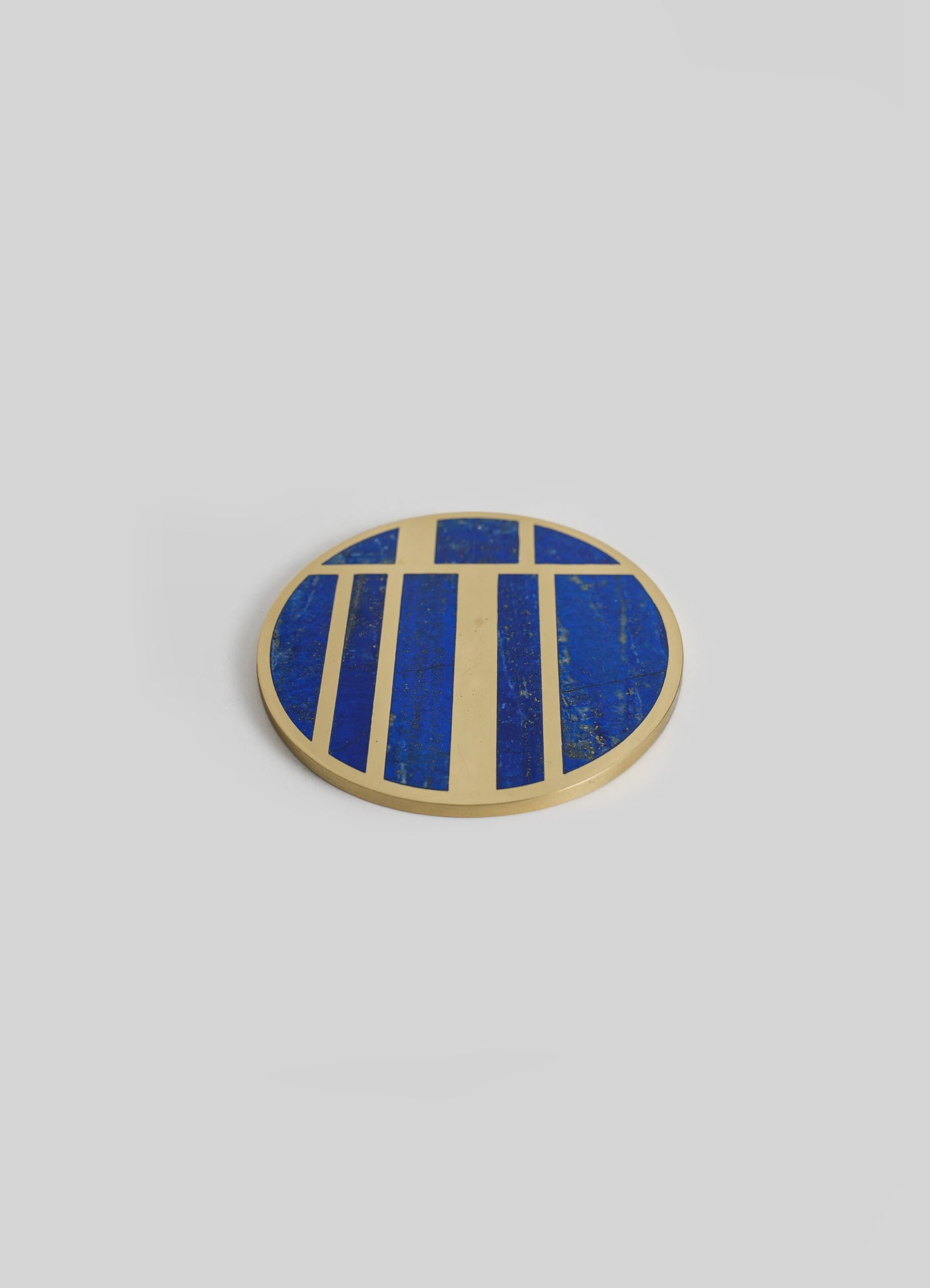 Round decorative tray with a geometric pattern in royal blue and beige tones, featuring a metallic gold border.