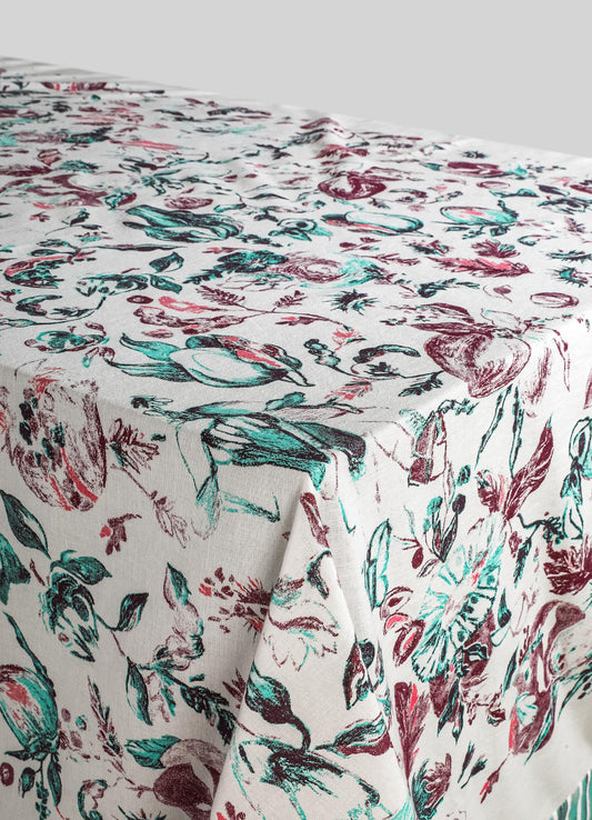 Printed table linen with a floral pattern in shades of red, teal, and black on a white background, made from a lightweight fabric ideal for casual or elegant dining settings.