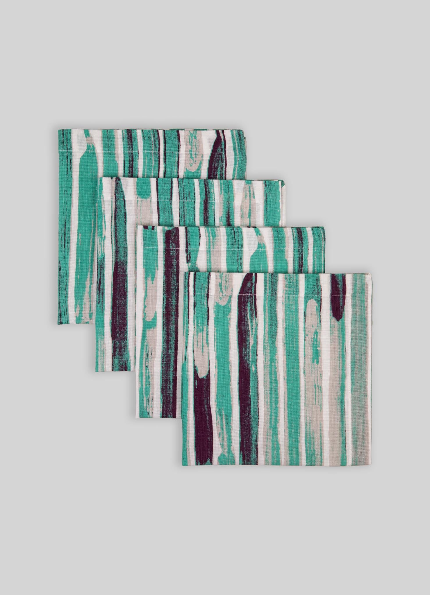 Set of fabric napkins with an abstract striped pattern in shades of teal, black, and white. Made of cotton with a contemporary style and soft, smooth texture.