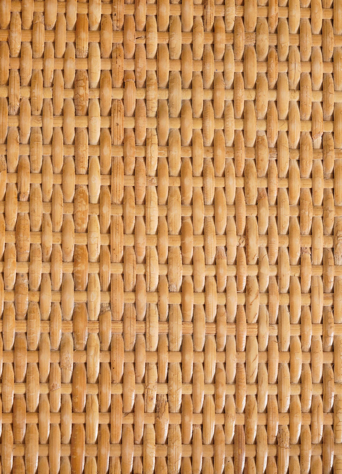 Woven rattan surface in a tight, hexagonal pattern with a warm, natural wood-tone finish.