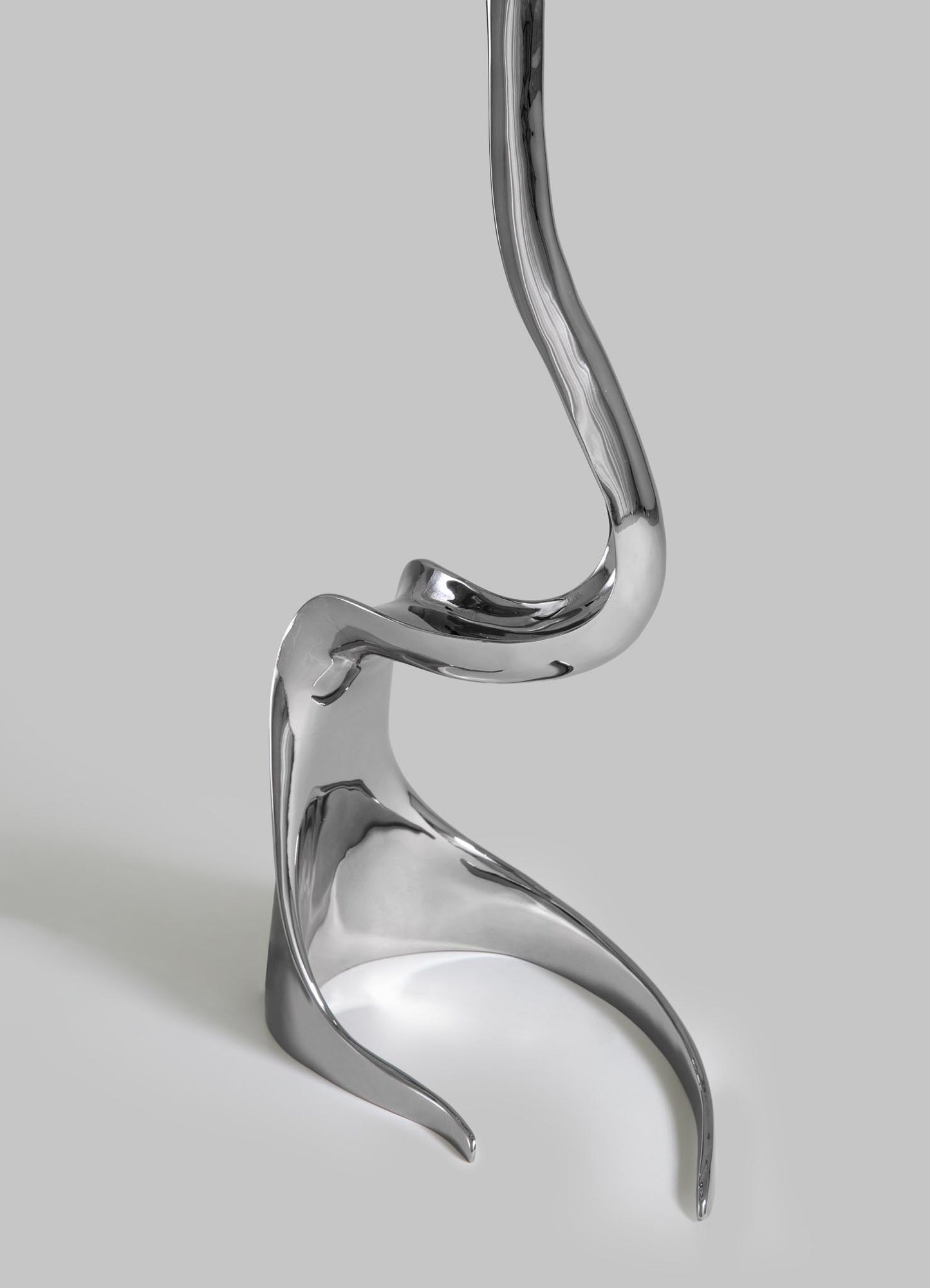 Metallic earring on a light gray background viya designer luxury table lamp