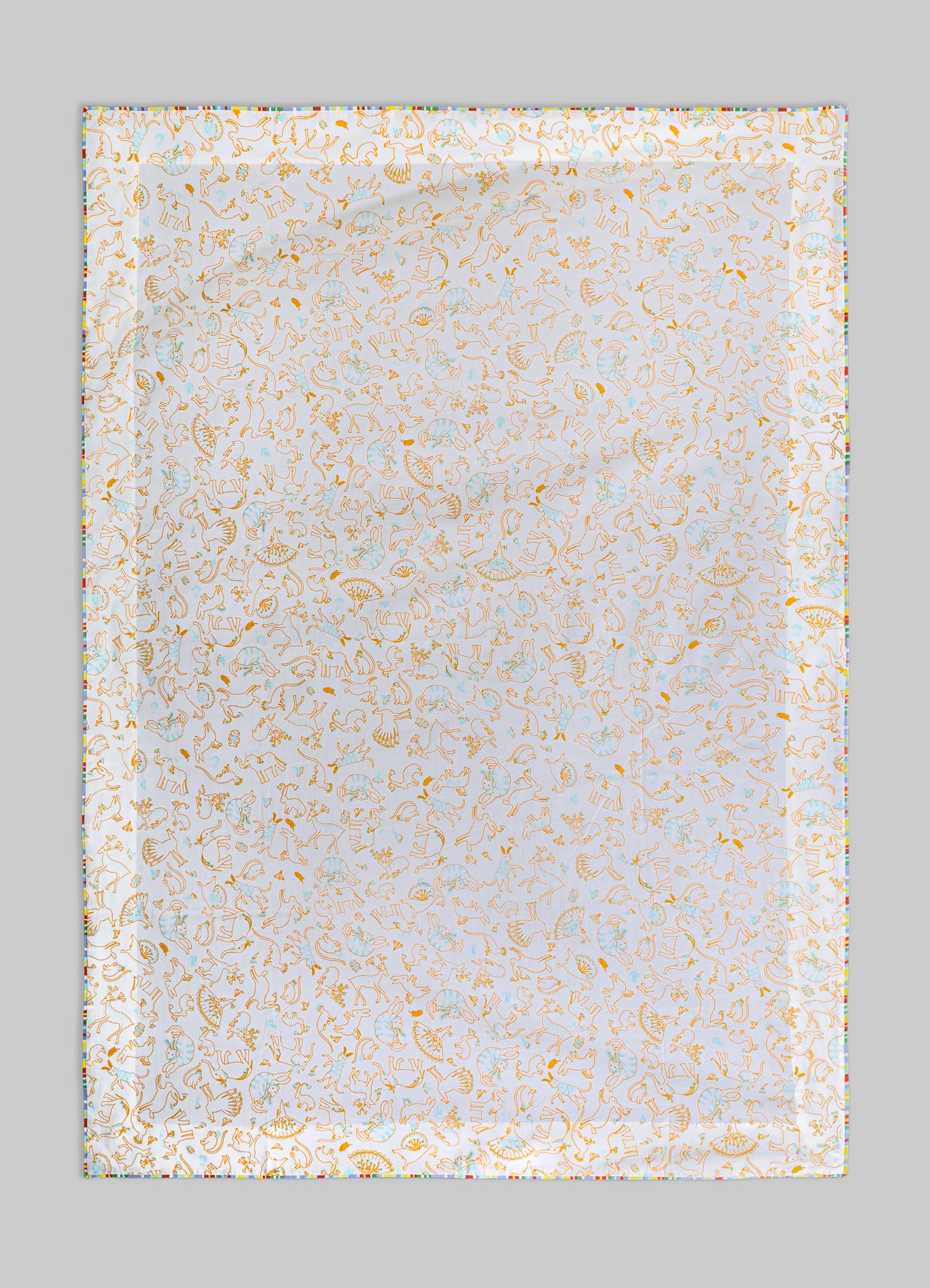 A fabric or textile piece featuring a detailed print of orange and light blue line drawings of horses, shells, and fans on a white background. The edges are bordered with a multicolored striped pattern, giving it a vibrant and playful appearance.