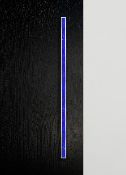A vertical strip of blue marble with gold trim, set against a split black and white textured background.