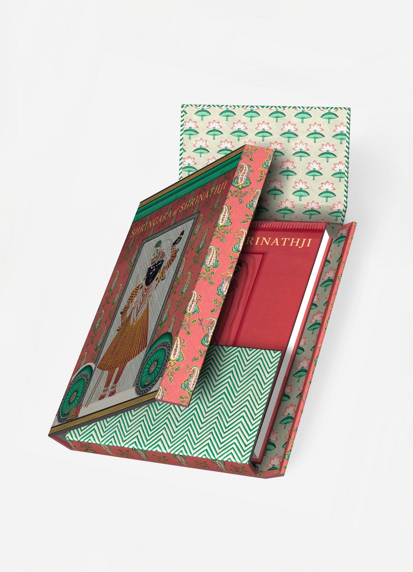 A decorative box with a floral motif and pink background, containing illustrated hardcover books; the interior lining features a green and white geometric pattern.